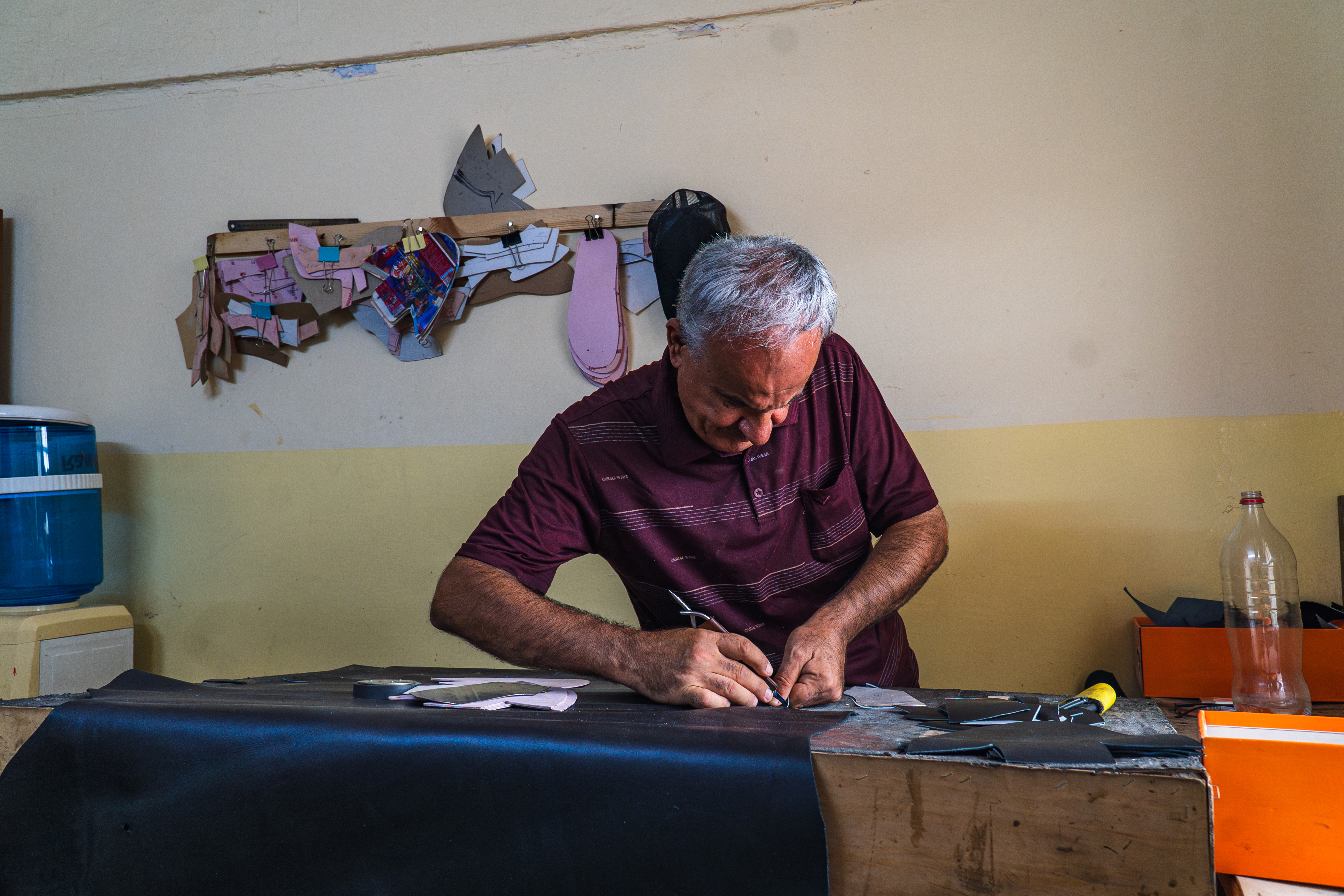 Saad’s hands remain quick and precise after more than four decades of shoemaking. Photo: IOM 2025/Aram Hakim