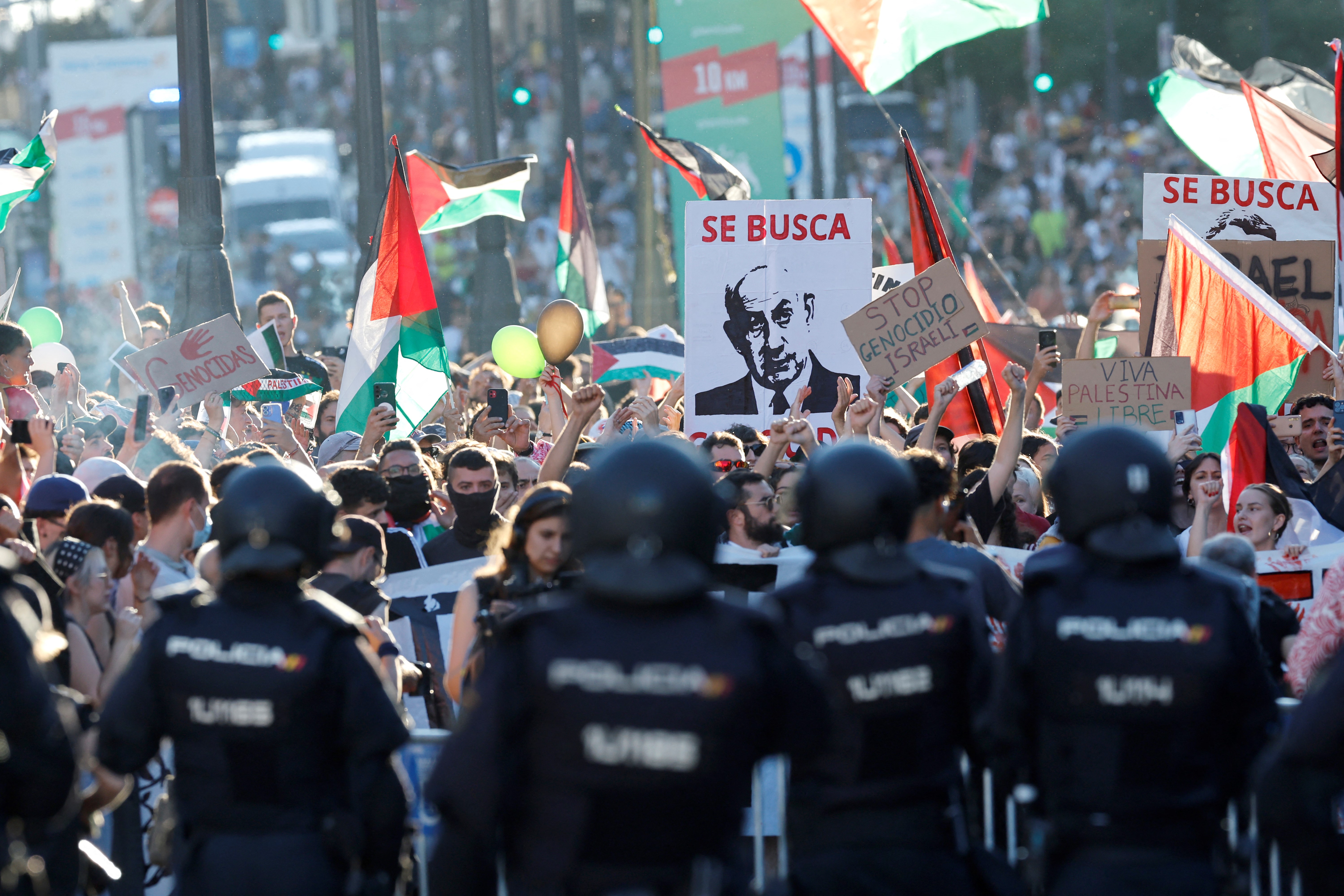 Pro-Palestinians protestors hold a banner reading '(Israel's Prime Minister Netanyahu) wanted' after invading the street during the 21st and last stage of the Vuelta a Espana 2025, in Madrid on September 14, 2025.