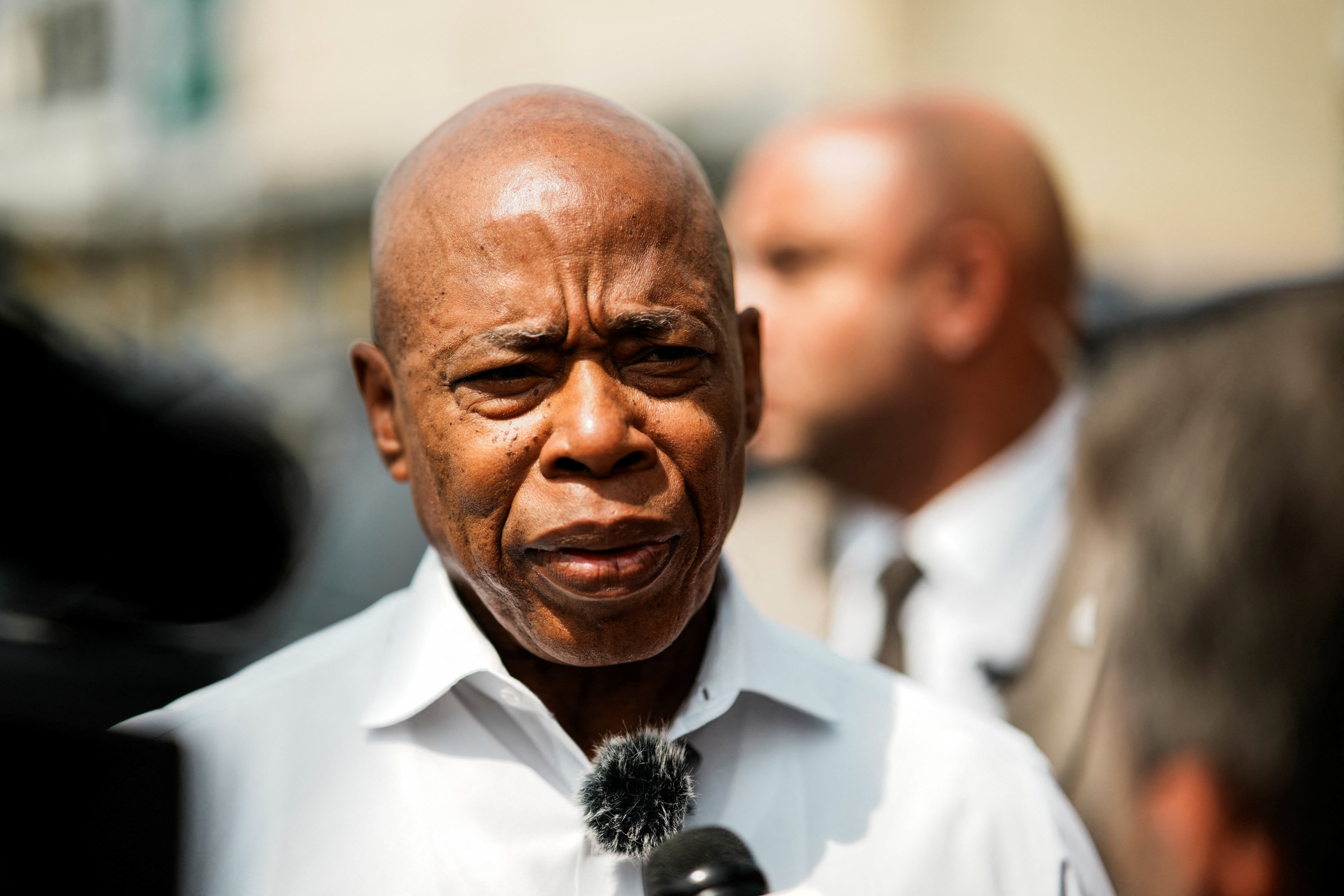 New York City Mayor Eric Adams, speaks with journalist as he attends a ribbon-cutting ceremony at his Queens campaign office in Queens, New York City, U.S., August 14, 2025. REUTERS/Eduardo Munoz