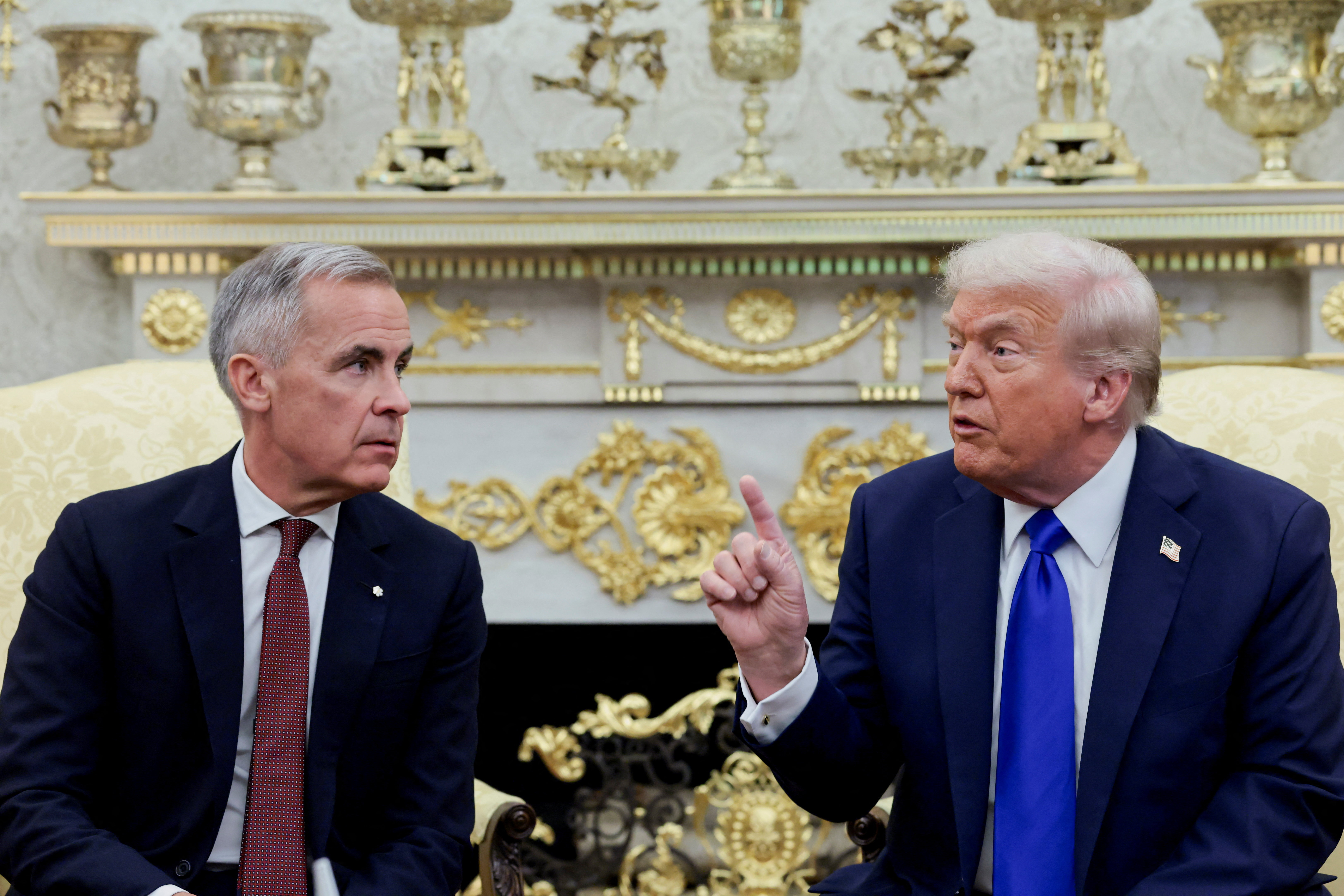 U.S. President Donald Trump gestures as he and Canada's Prime Minister Mark Carney meet in the Oval Office at the White House in Washington, D.C., U.S., October 7, 2025. REUTERS/Evelyn Hockstein