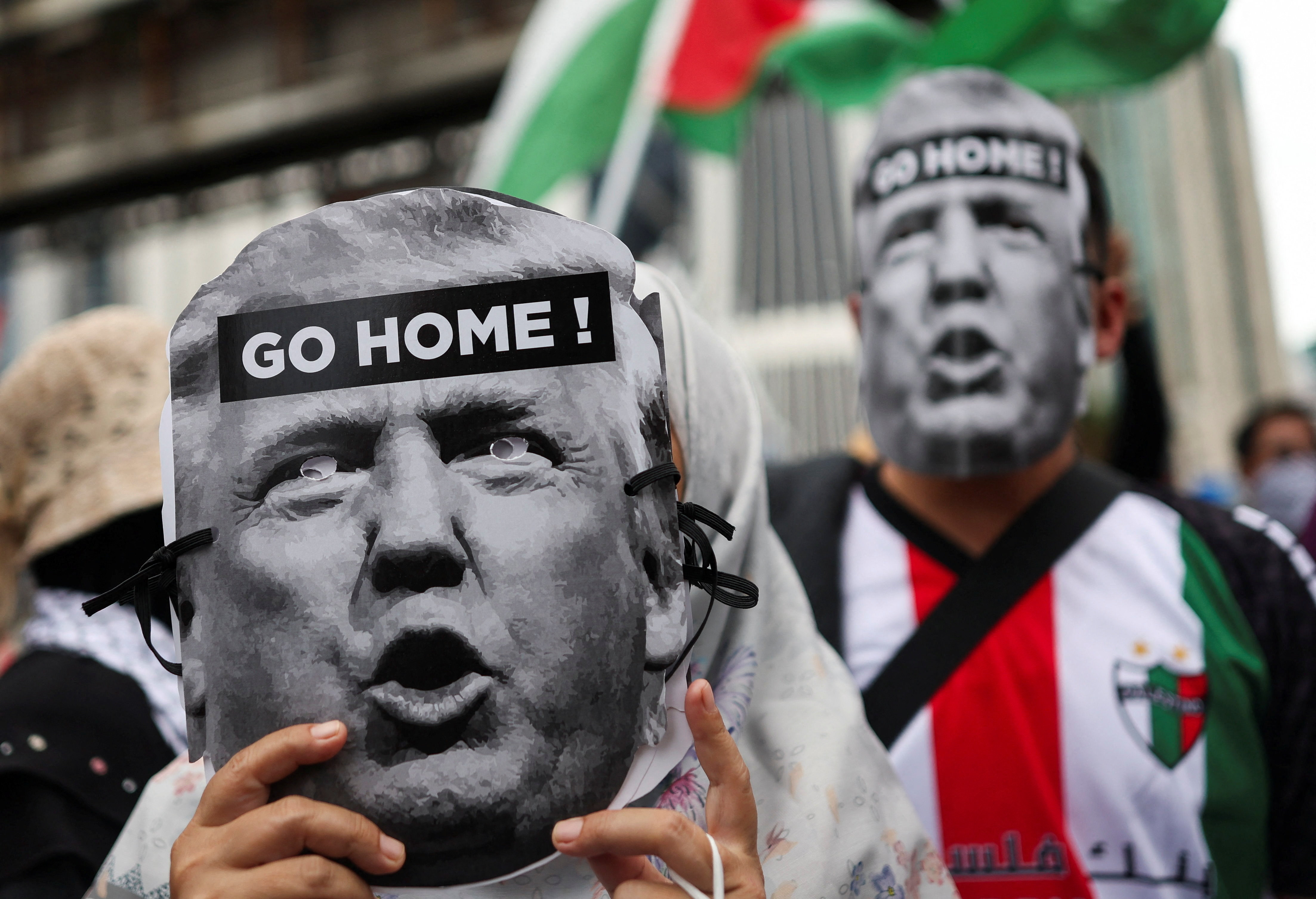 Pro-Palestinian demonstrators hold cutouts of US President Donald Trump&rsquo;s face on October 24, 2025, as they march to the US embassy to protest the president&#039;s visit to Malaysia for the ASEAN summit in Kuala Lumpur [Hasnoor Hussain/Reuters]