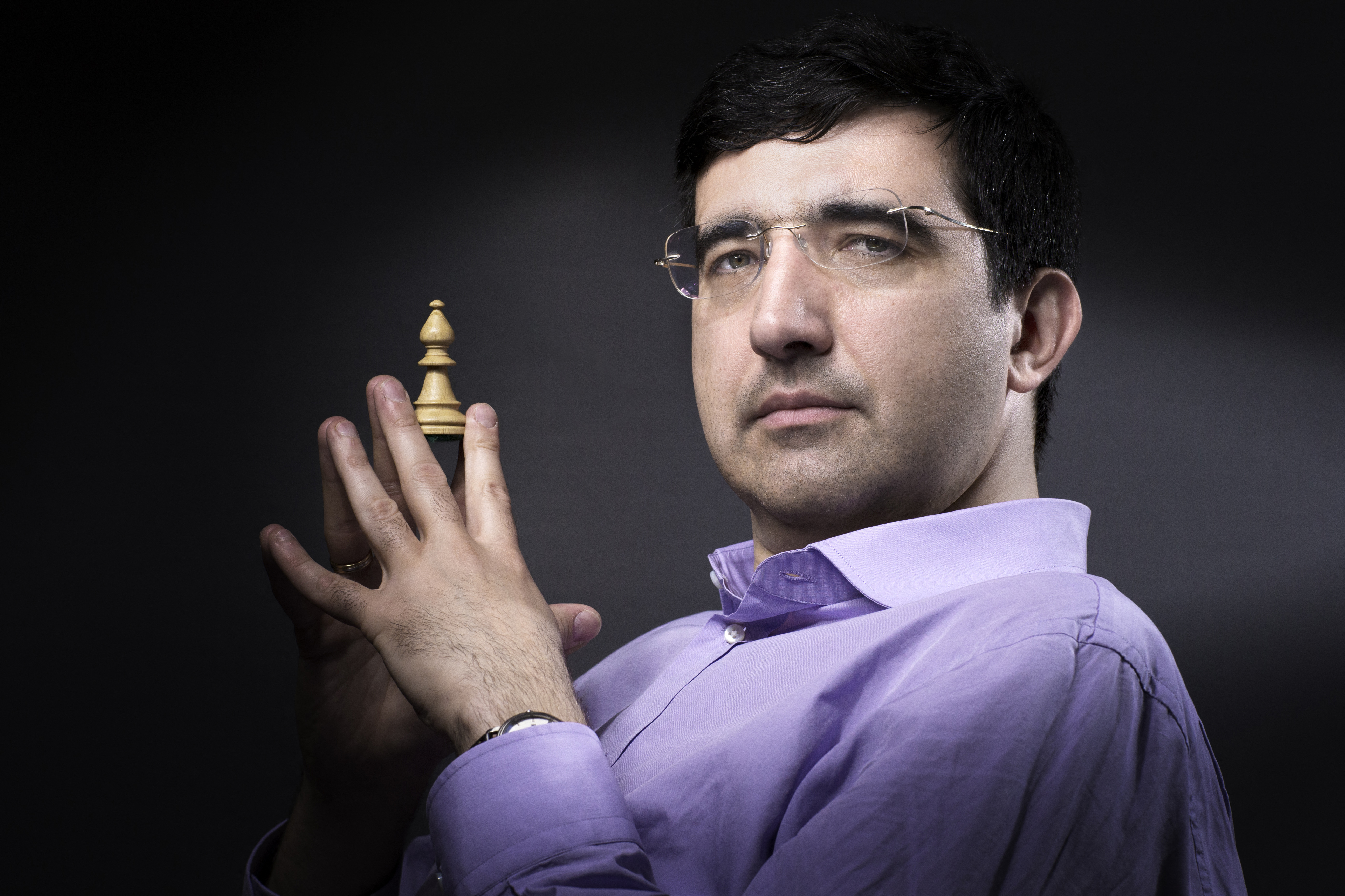 Russian chess Grandmaster Vladimir Kramnik and the third highest ranked player in the world poses with his favorite chess piece (a bishop) on June 8 ,2016 in Paris. The first leg of the 2016 Grand Chess Tour is set to take place from June 9 to 12 at La Maison de la Chimie in Paris. (Photo by JOEL SAGET / AFP)