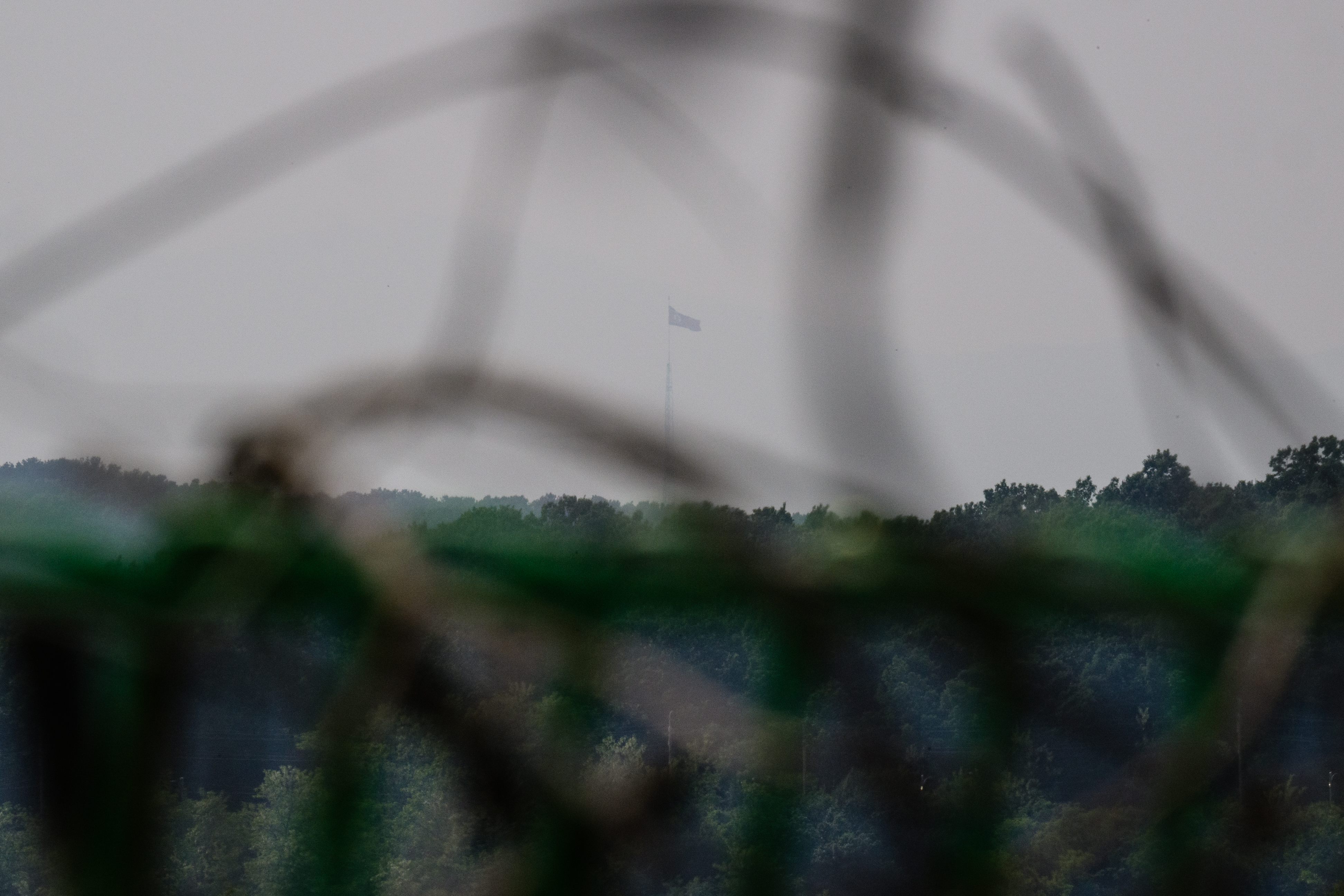 A North Korean flag flutters in the wind, as seen from Tongilchon, or Unification Village, on May 28, 2025, located some 60 kilometers from Seoul in the Civilian Control Zone (CCZ), a restricted area next to the more famous Demilitarised Zone (DMZ) that separates the two Koreas. Their village is just a stone's throw from North Korea. So whatever their political leanings, Tongilchon residents all want one thing: a South Korean president who doesn't stoke tensions with Pyongyang. (Photo by ANTHONY WALLACE / AFP) / TO GO WITH: SKOREA-VOTE-NKOREA-POLITICS BY ROLAND DE COURSON AND MINJI SUH