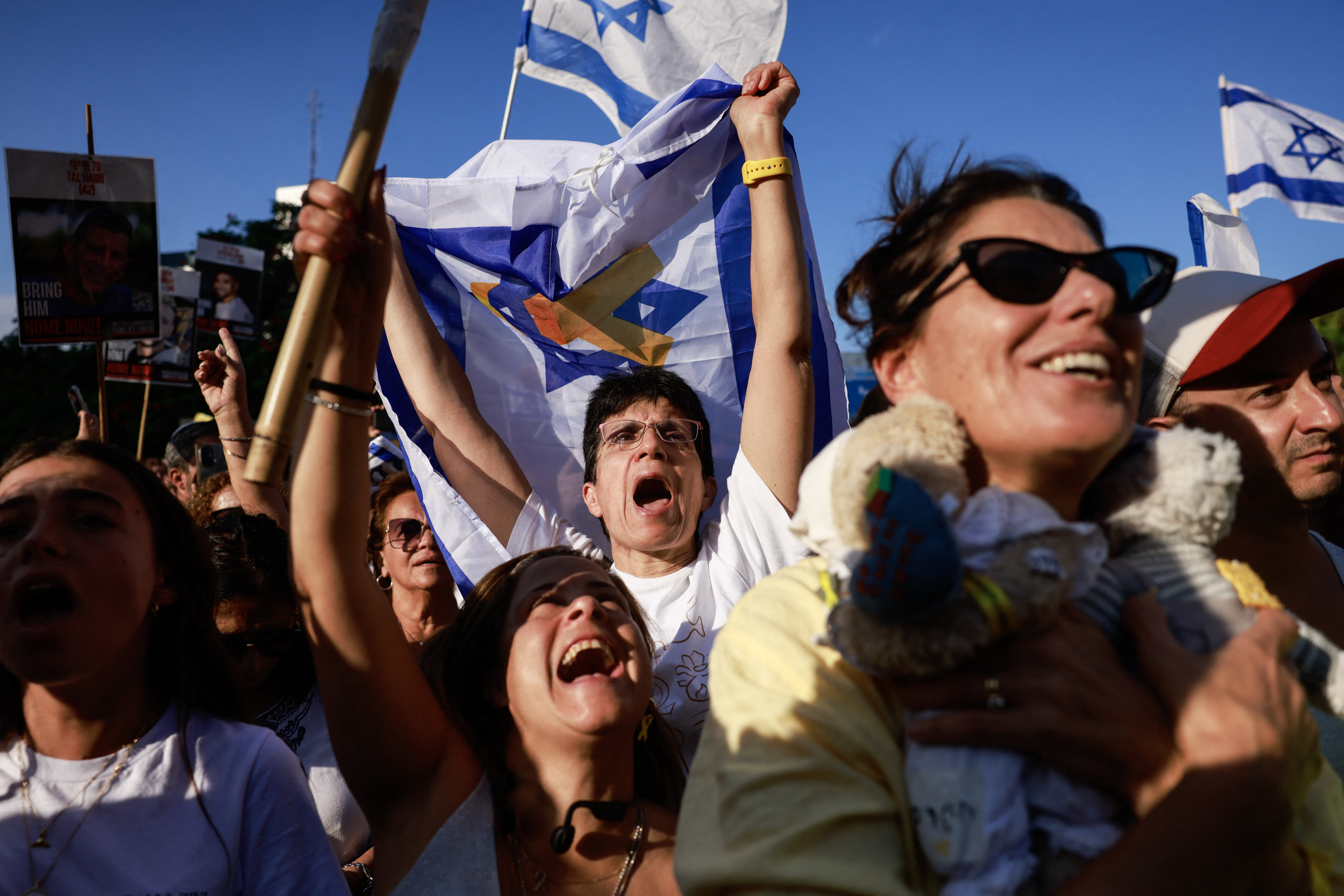 People celebrate at Hostage Square in Tel Aviv as news came out that Hamas has already handed over seven surviving hostages to the Red Cross