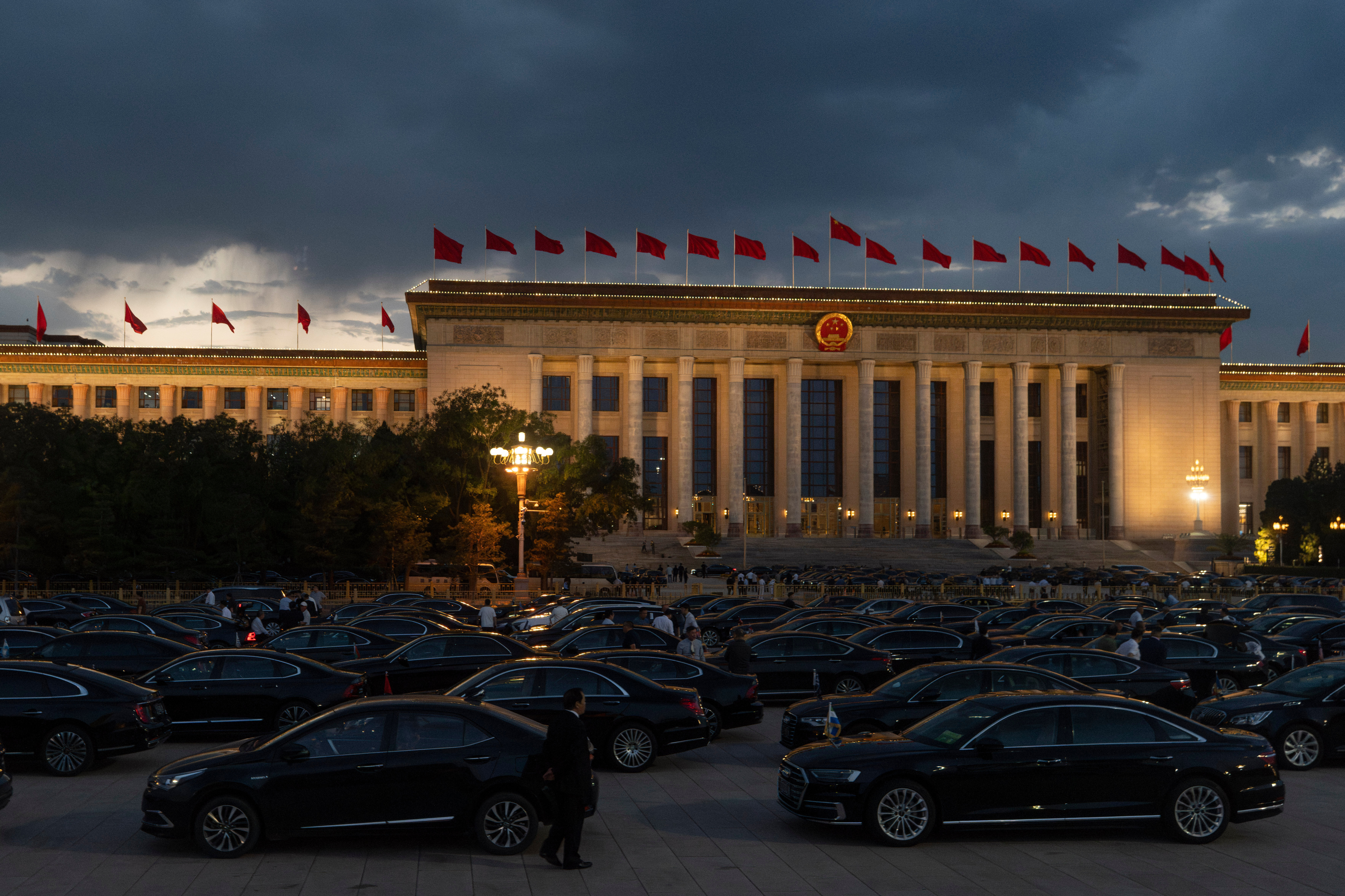 Drivers wait for attendees of the National Day Reception held at the Great Hall of the People on the eve of the 76th anniversary of the founding of the People's Republic of China in Beijing, China,