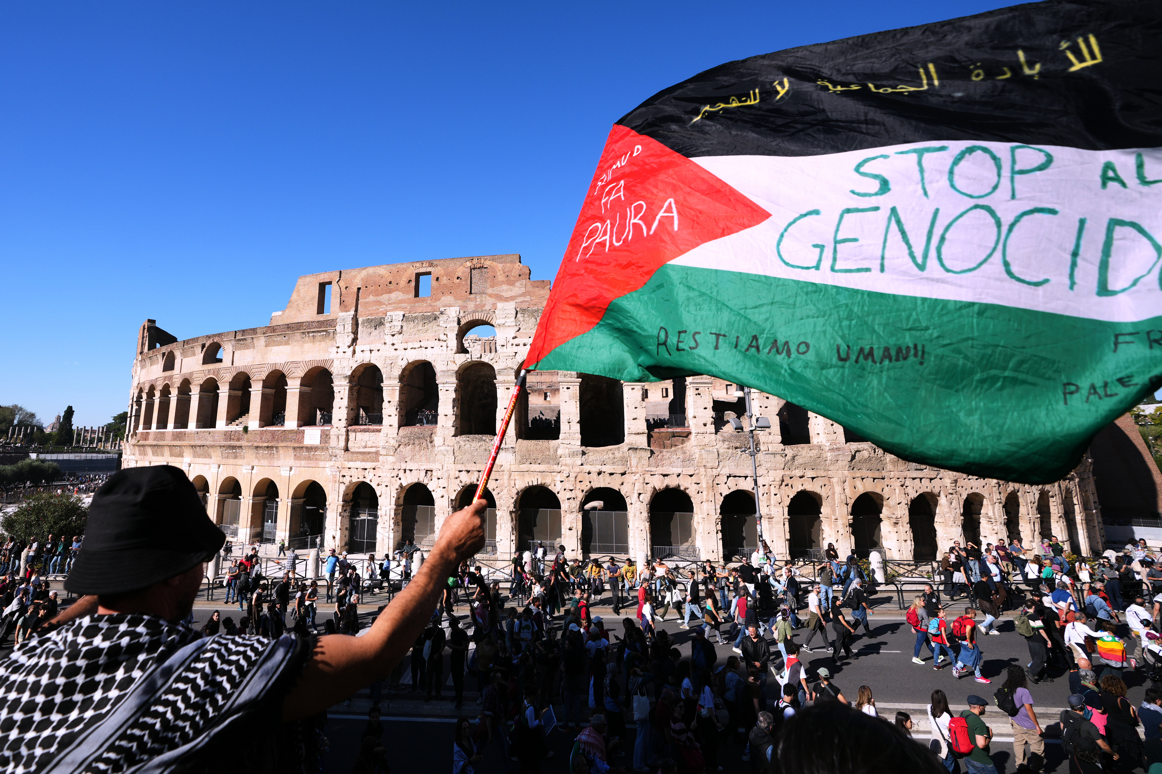 Pro-Palestinian demonstrators pass in front of Rome's Colosseum, Saturday, Oct. 4, 2025, during a march calling for an end to the war in Gaza