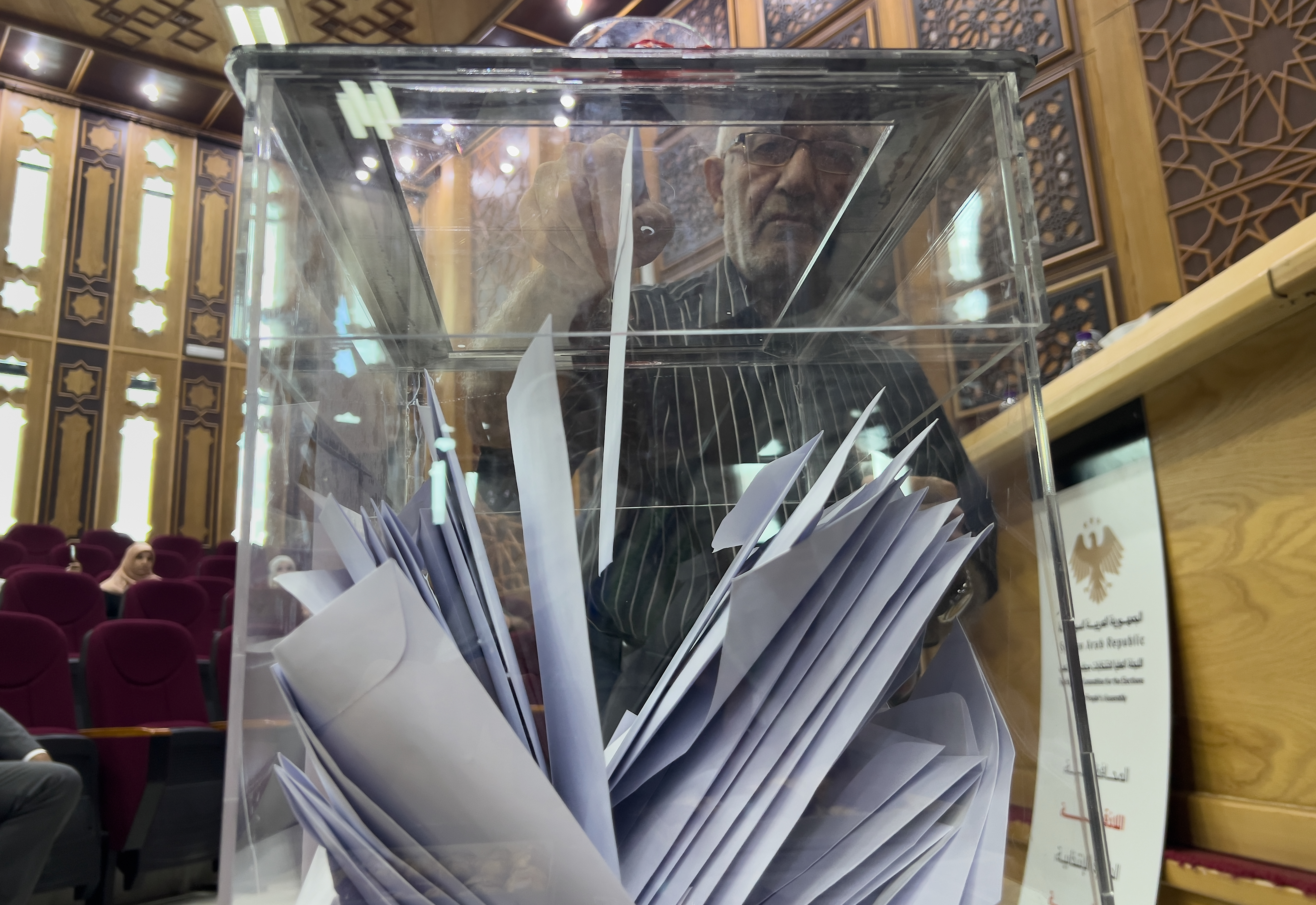 A Syrian electoral college member casts his vote during a parliamentary election at Latakia's Governor ballot station in Latakia