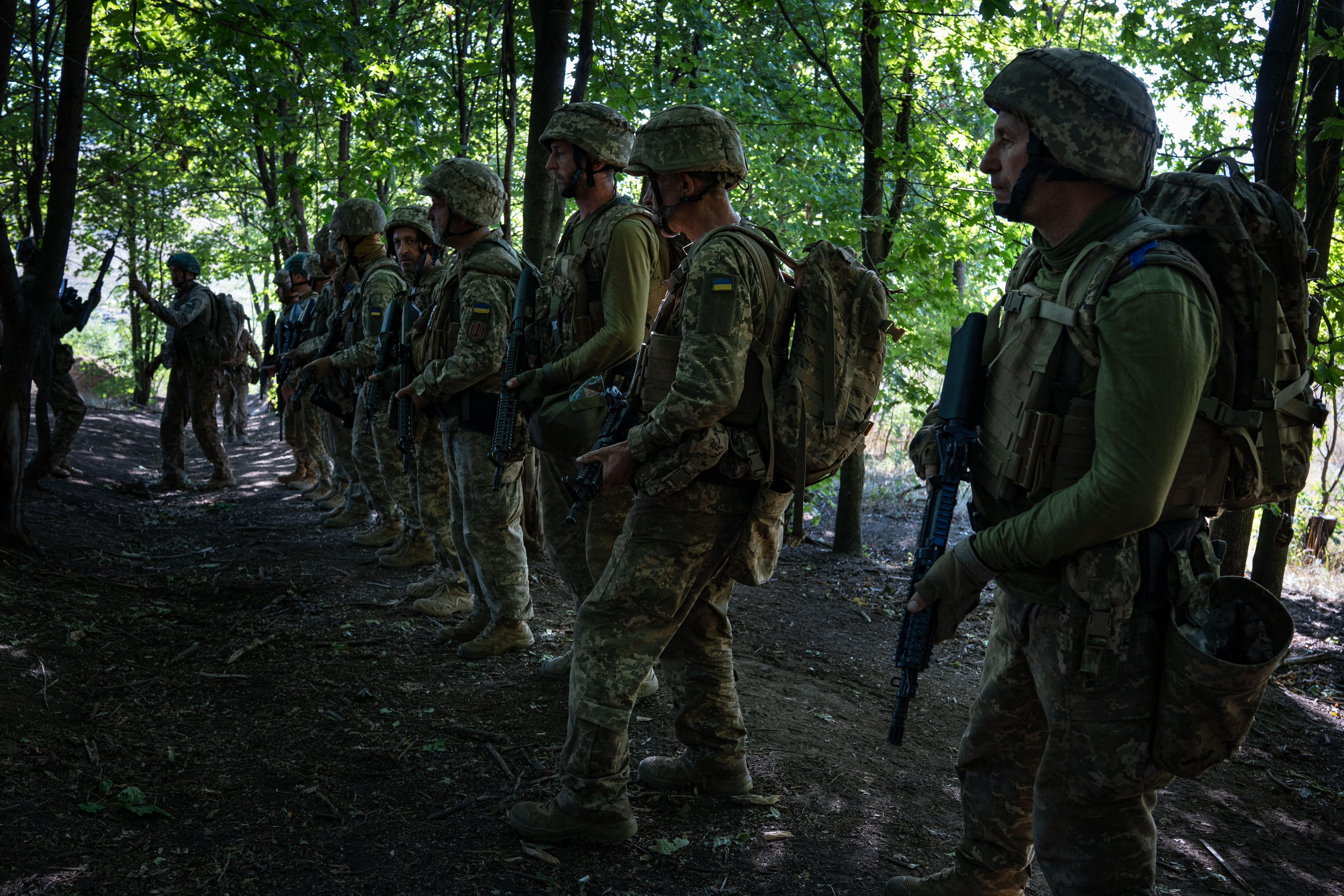 Soldiers from the assault unit of Ukraine&#039;s 25th Brigade receive instructions before starting training in the Donetsk region, part of the Donbas region Russia has laid claim to [Ximena Borrazas/SOPA Images/LightRocket via Getty Images]