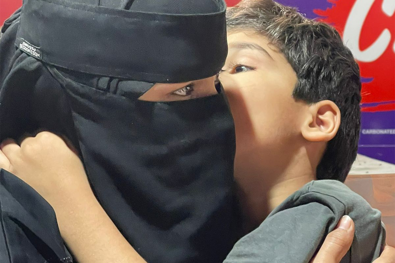 Kashmiri boy, with his mother before she was deported to Pakistan