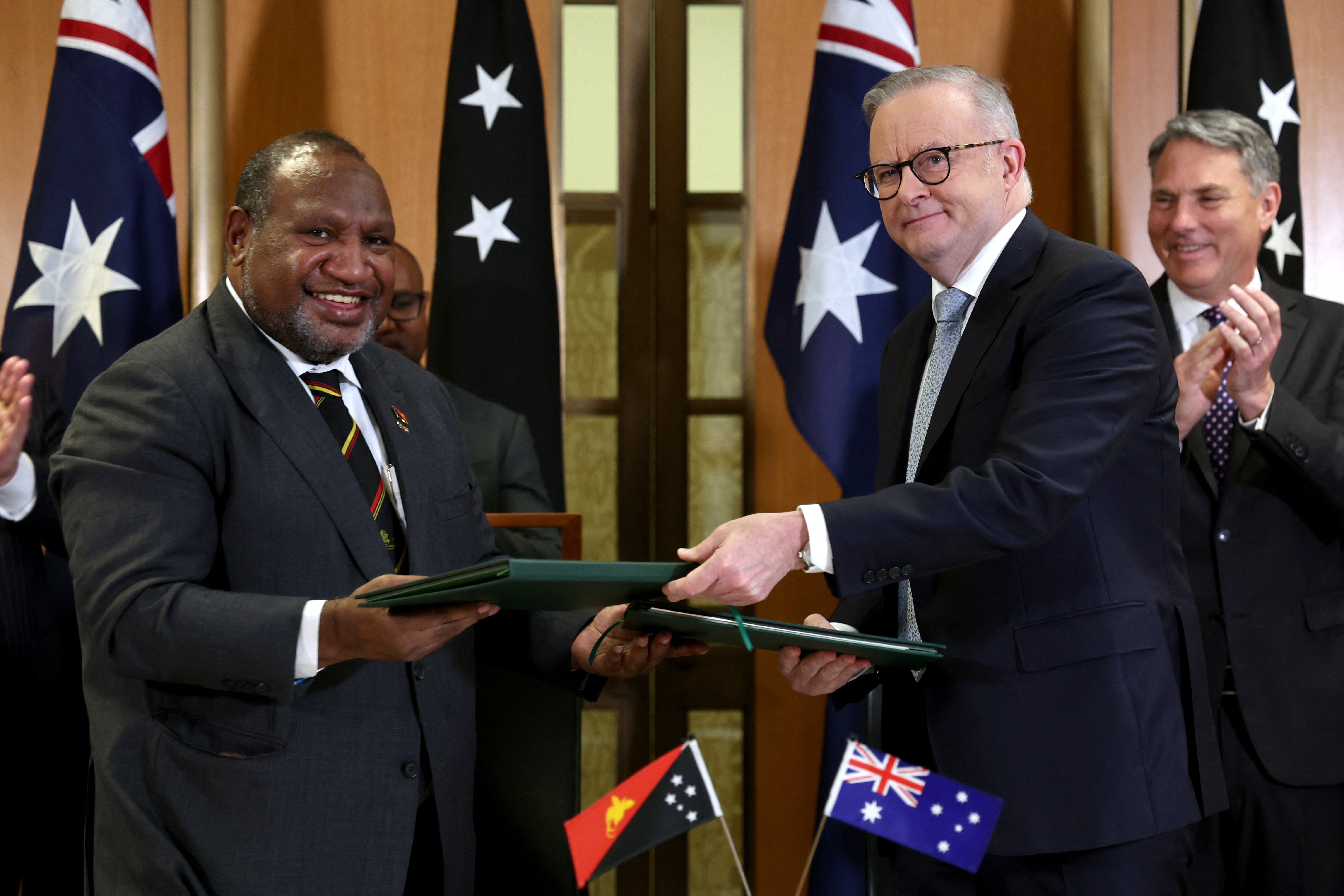 Australia's Prime Minister Anthony Albanese (2nd R) and Papua New Guinea's Prime Minister James Marape (L) sign the Pukpuk treaty at Parliament House in Canberra on October 6, 2025.