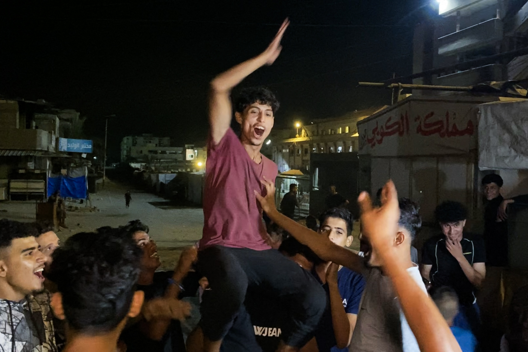 TOPSHOT - Palestinians celebrate in Khan Yunis on October 9, 2025, following news of a new Gaza ceasefire deal.