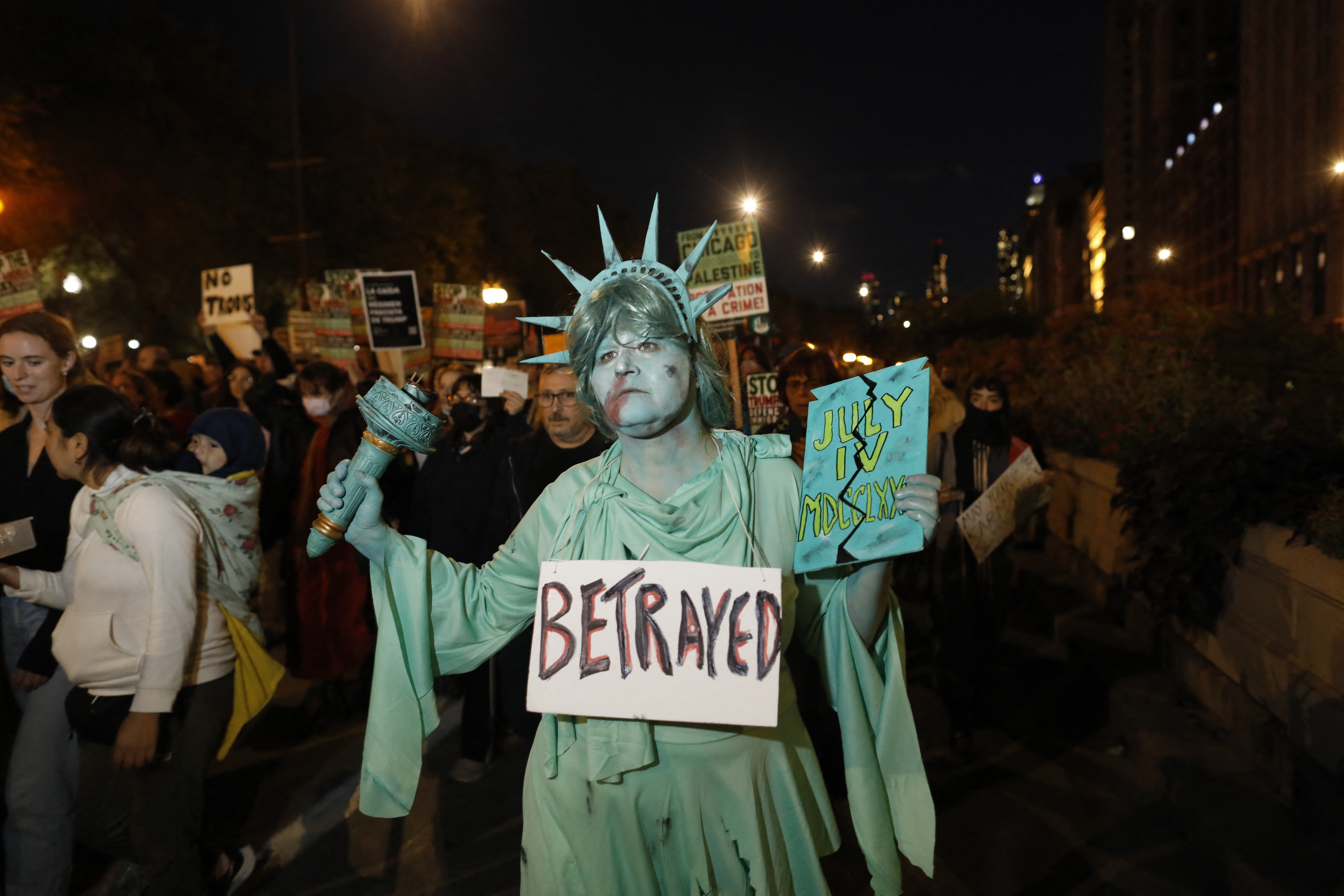 A protester, wearing a Statue of Liberty costume, attends a demonstration against the arrival of the Texas National Guard and US Immigration and Customs Enforcement agents in downtown Chicago, Illinois, on October 8, 2025.