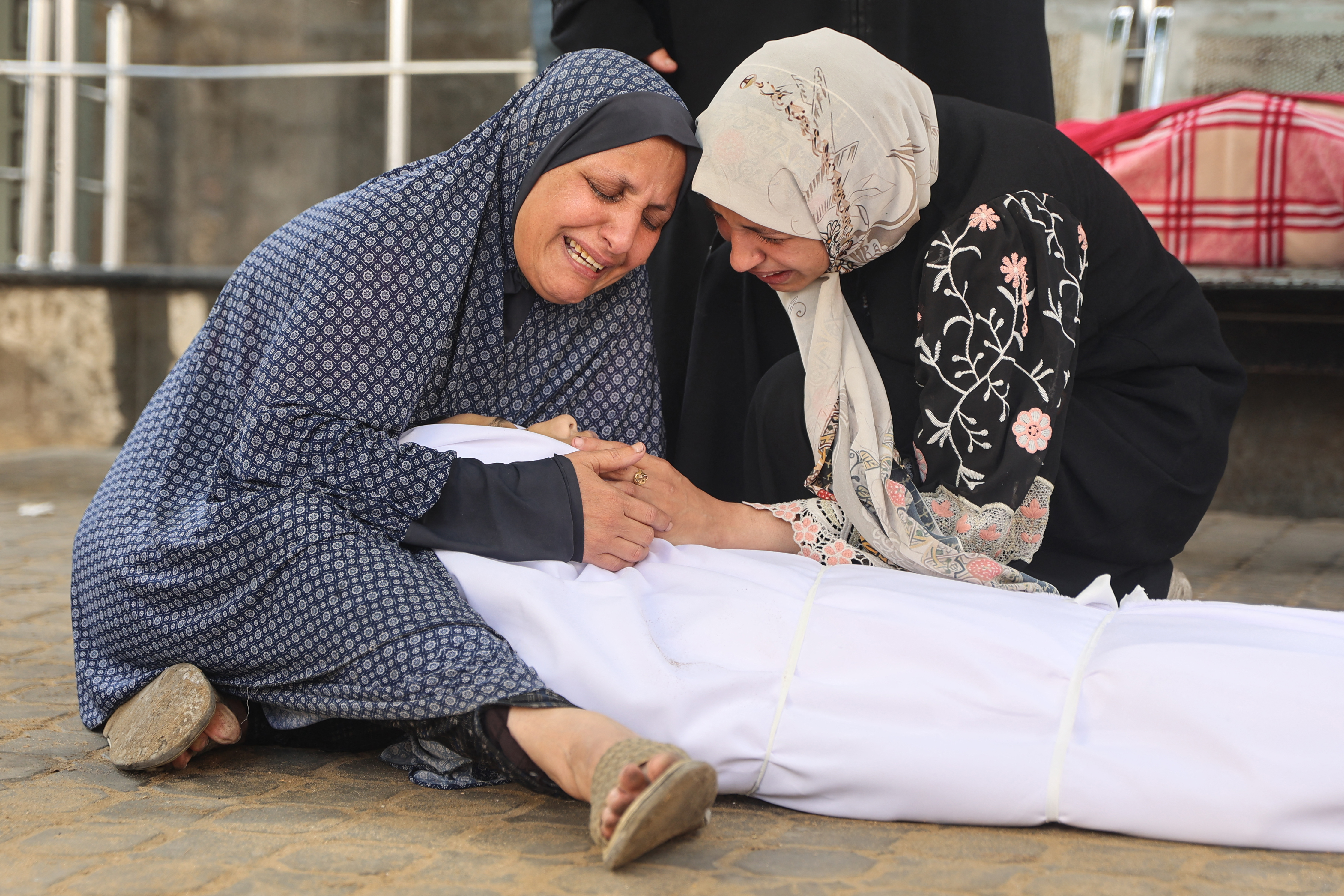 EDITORS NOTE: Graphic content / Palestinian Sanaa Al-Safadi (L) mourns over the body of her son Abdul Rahman, 15, who was killed in overnight Israeli strikes, at the Al-Shifa Hospital in Gaza City on October 29, 2025.
