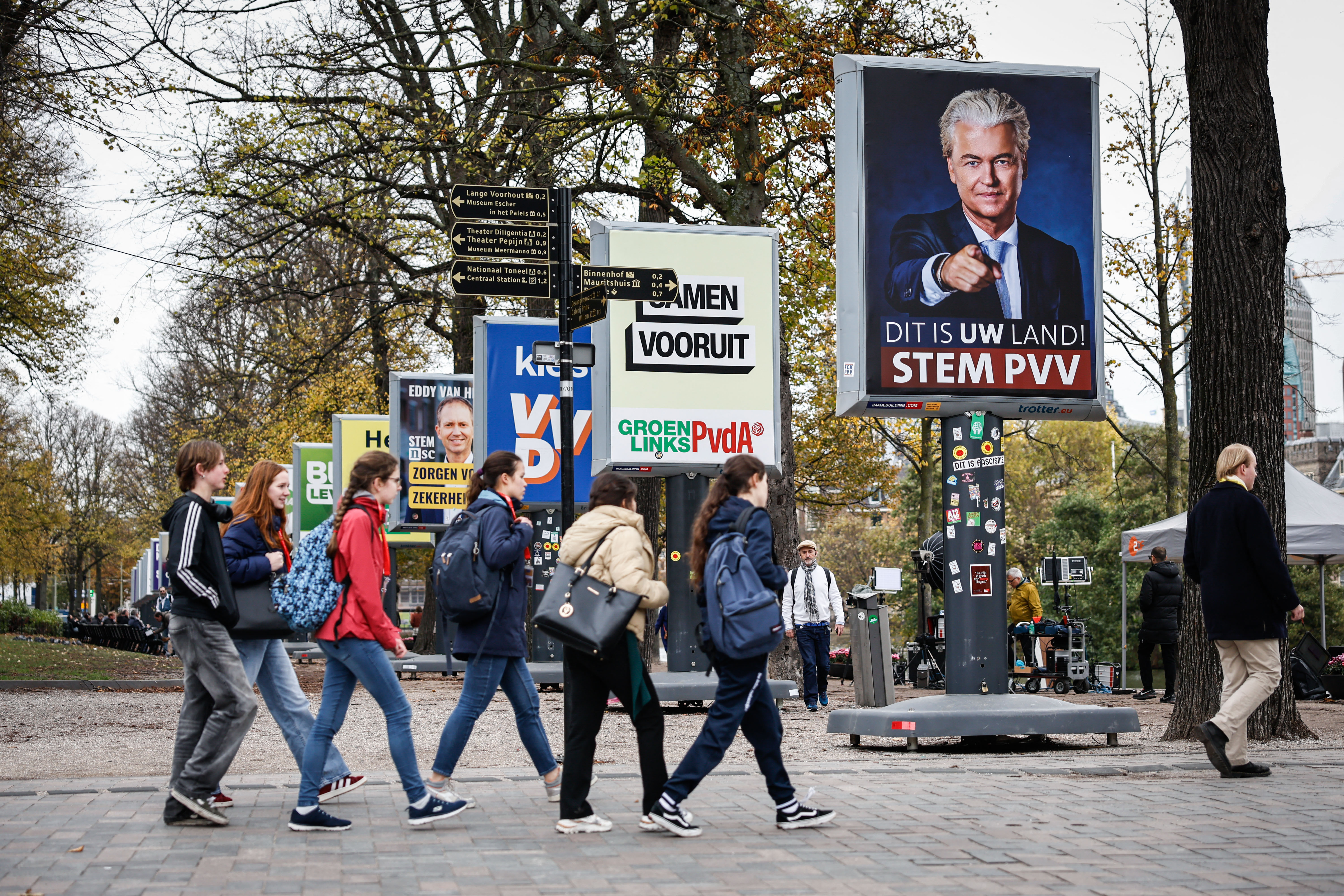 Pedestrians walk past posters of Dutch political parties in The Hague on October 29, 2025, in the day of the House of Representatives elections.