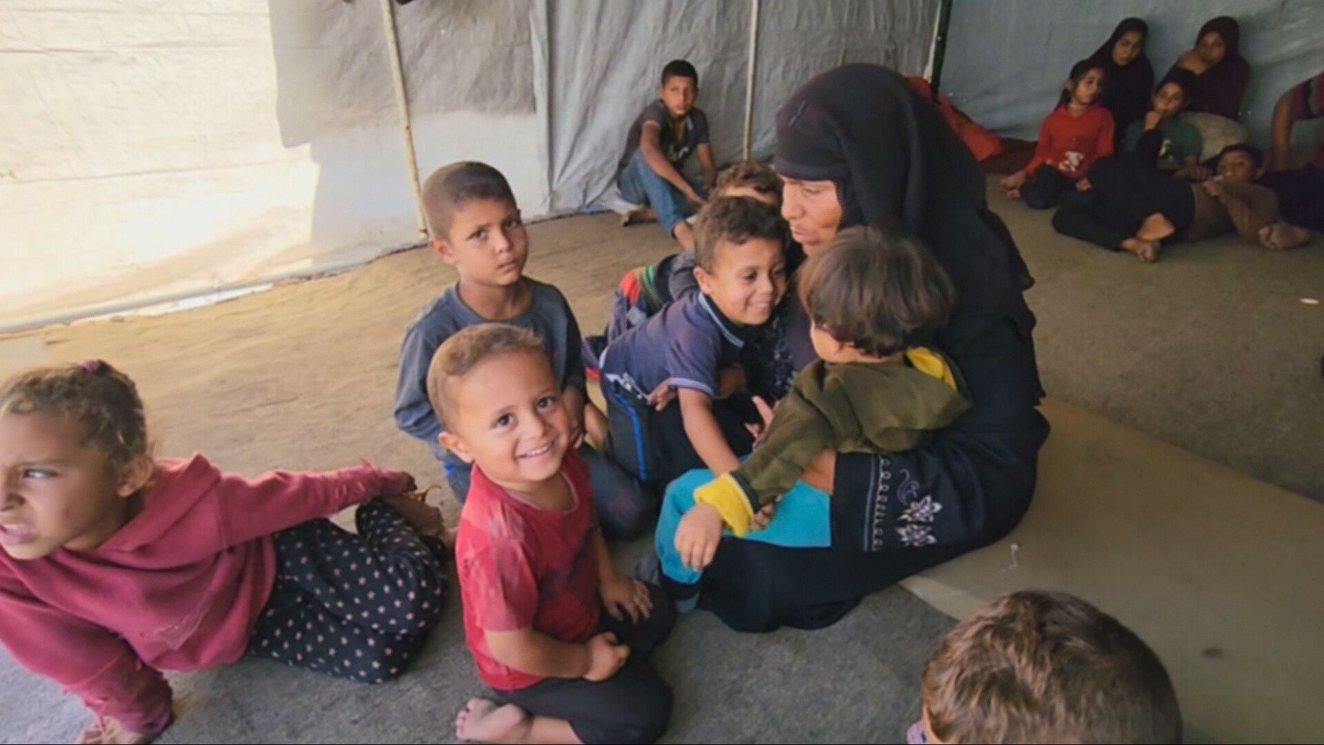 Rida Aliwa with her orphaned grandchildren in Gaza City [Screengrab/Al Jazeera]