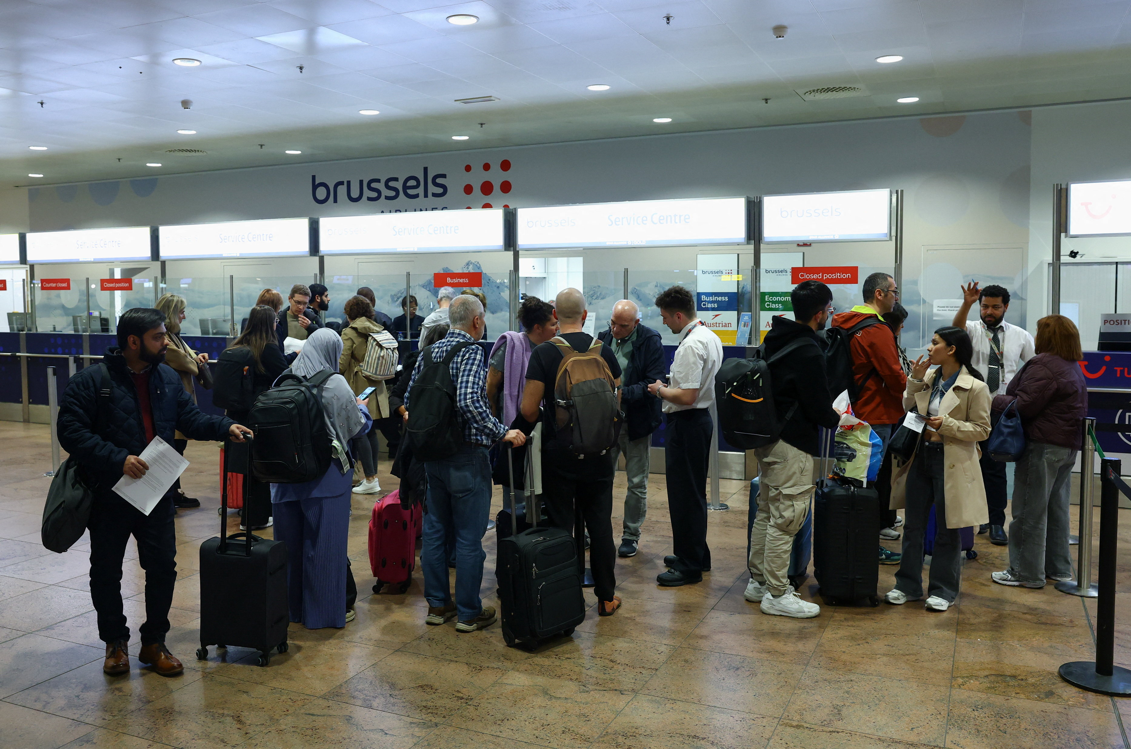 Passengers wait in line at a service desk at Brussels airport after the Belgian air traffic control service reported a sighting of a drone, in Zaventem, Belgium, November 4, 2025 [Yves Herman/REUTERS]