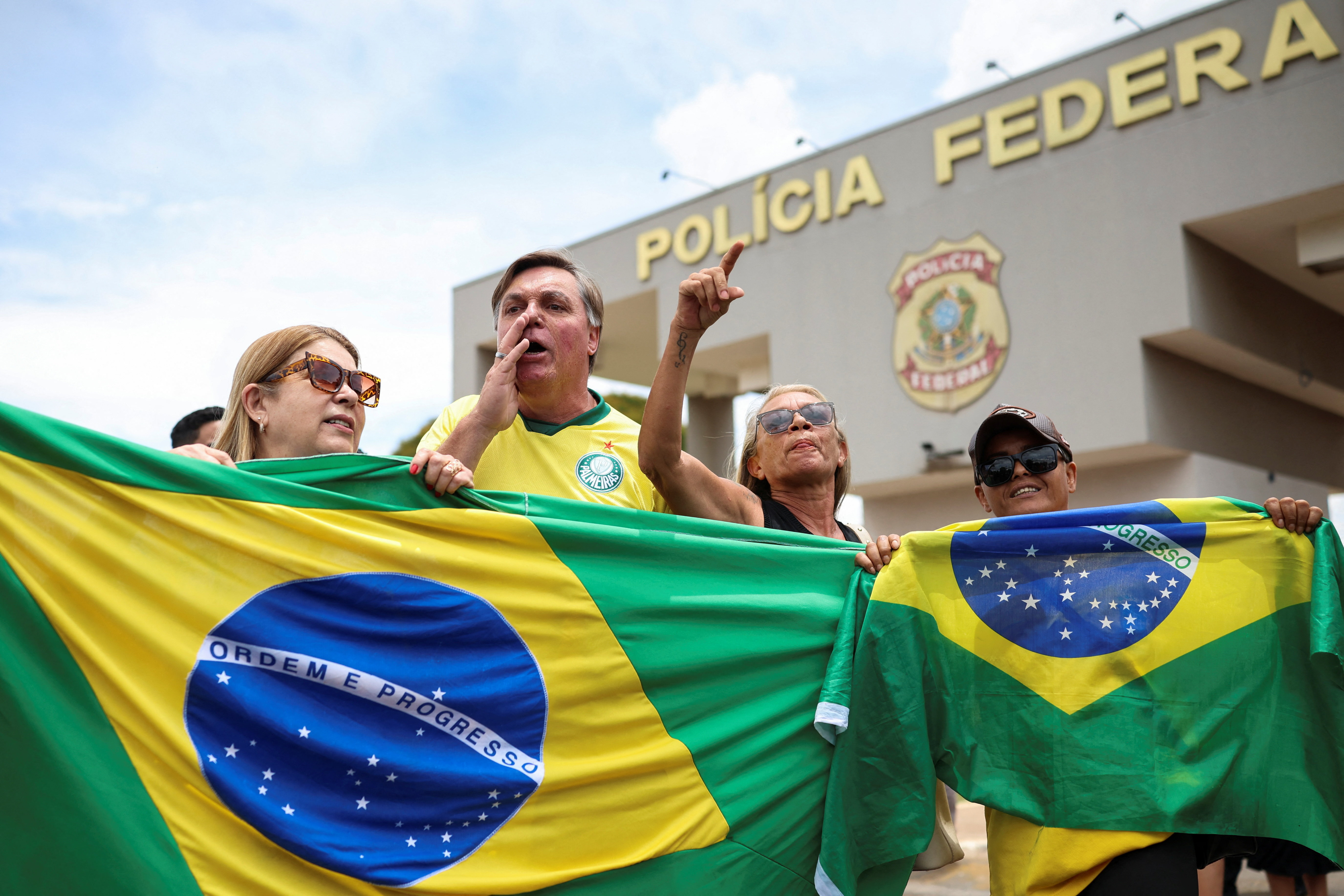 Bolsonaro's supporters rally on his behalf outside of police headquarters