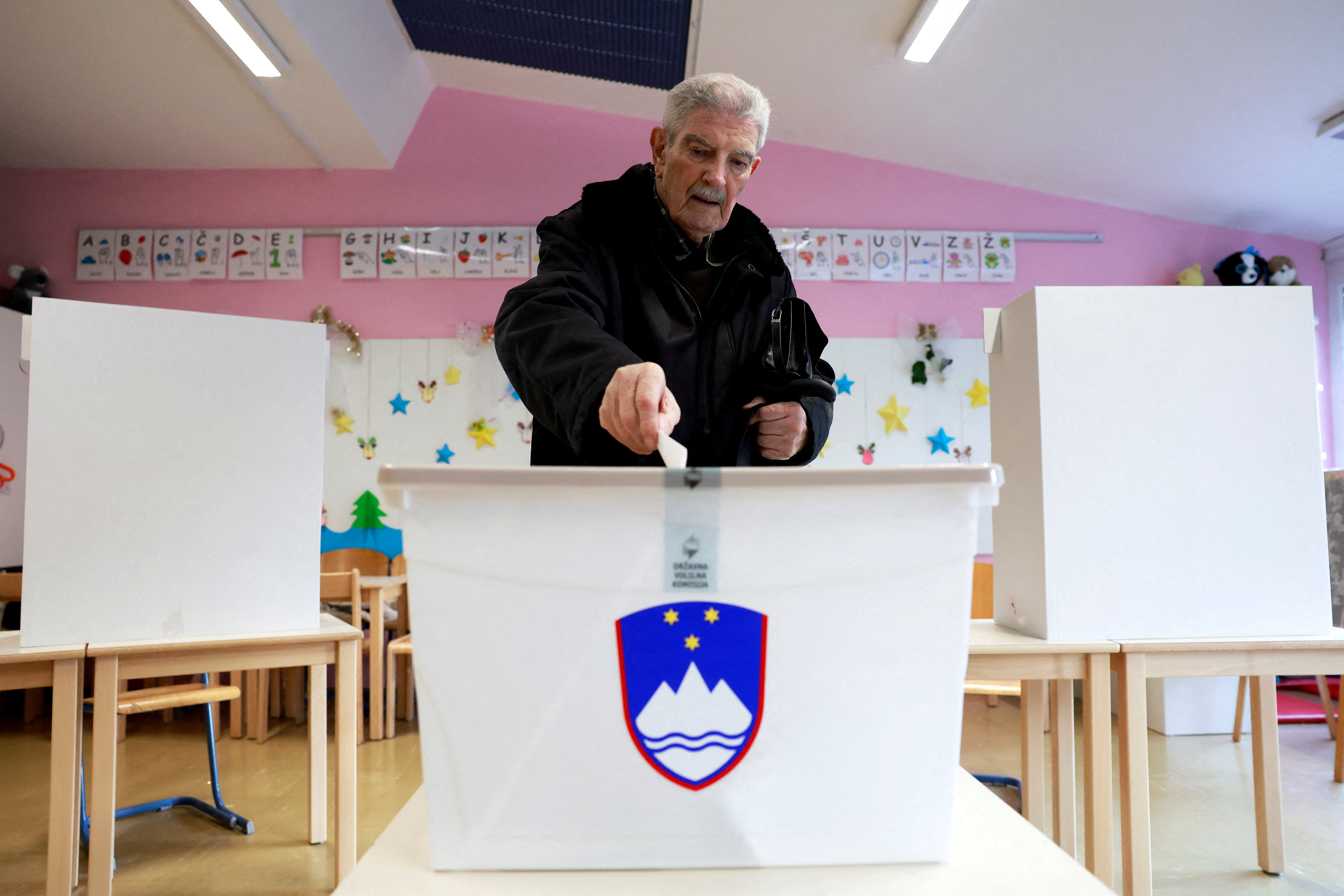A person casts their ballot at a polling station during a referendum vote on a law that proposes legalizing assisted dying for some terminally ill adults, in Ljubljana, Slovenia, November 23, 2025. [Borut Zivulovic/Reuters]