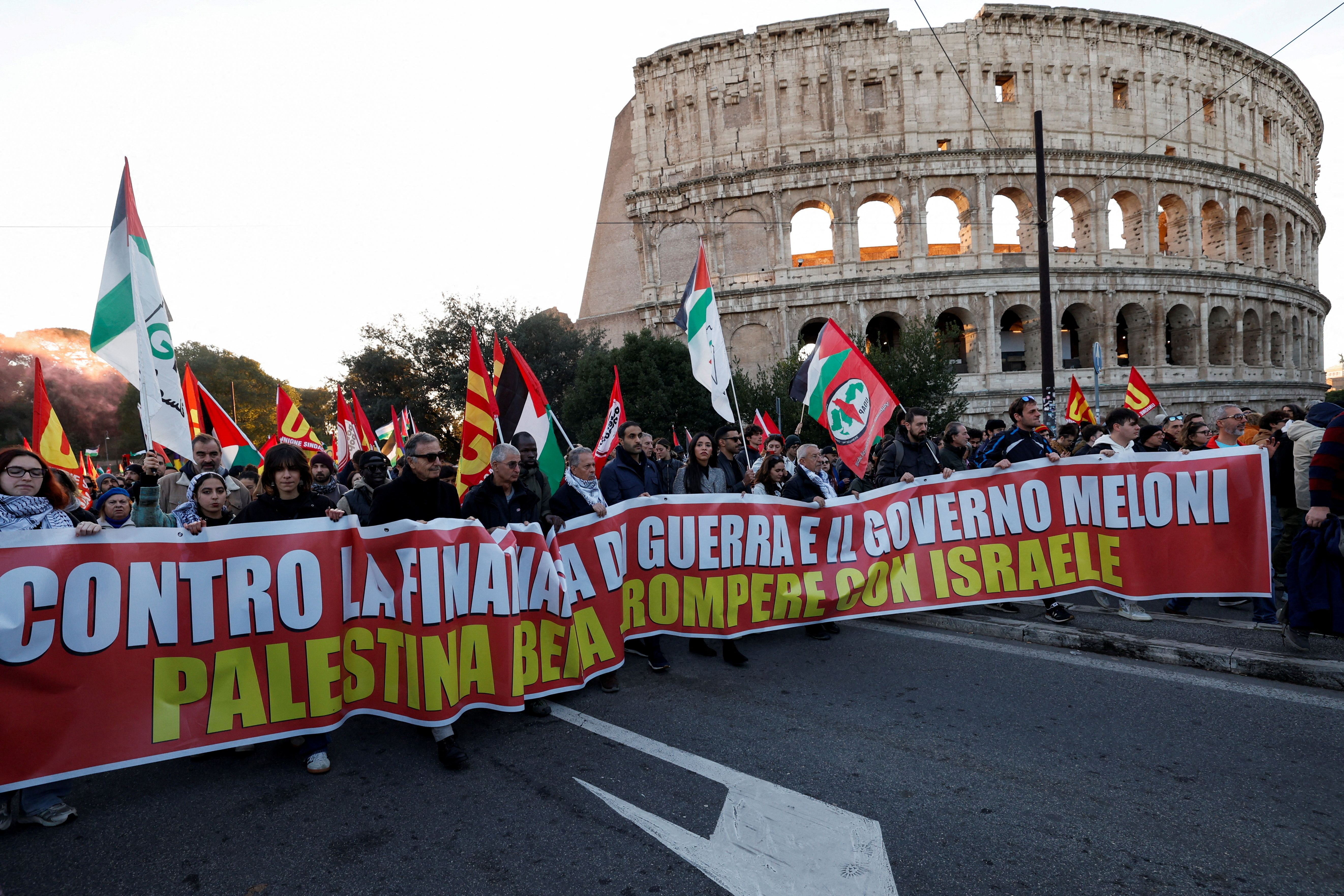 People carry a banner as they attend a demonstration during a nationwide strike, called by the USB union, in solidarity with Gaza and against the government and its plan to increase military spending, in Rome, Italy, November 29, 2025. REUTERS/Remo Casilli TPX IMAGES OF THE DAY