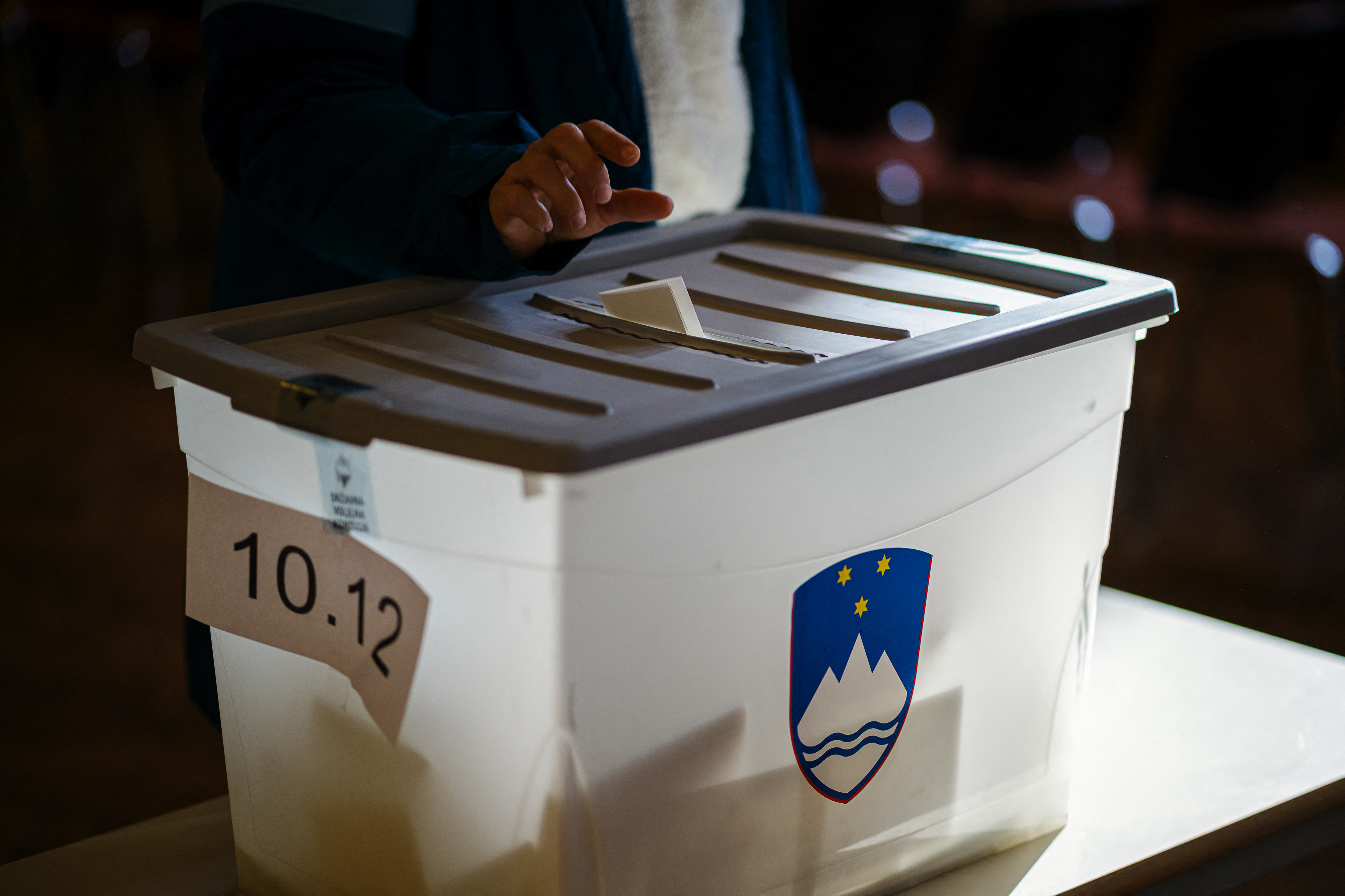 A voter casts a ballot in Slovenia's assisted dying referendum at a polling station in Radomlje on November 23, 2025.