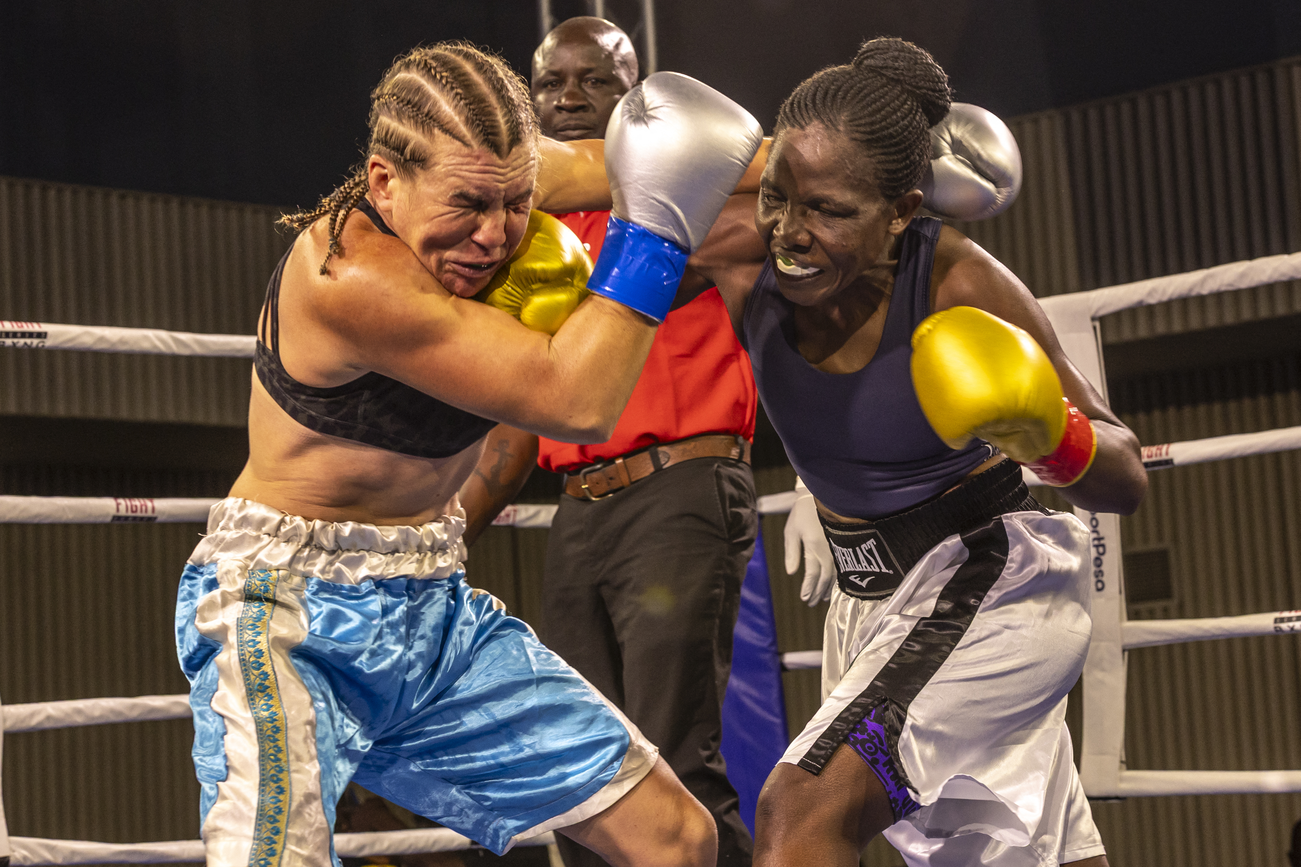 Sweden's Sandra Attermo (L) fights against Kenya's Consolata Musangi during their Women Super Bantamweight boxing title bout at the Edge Convention Centre, in Nairobi