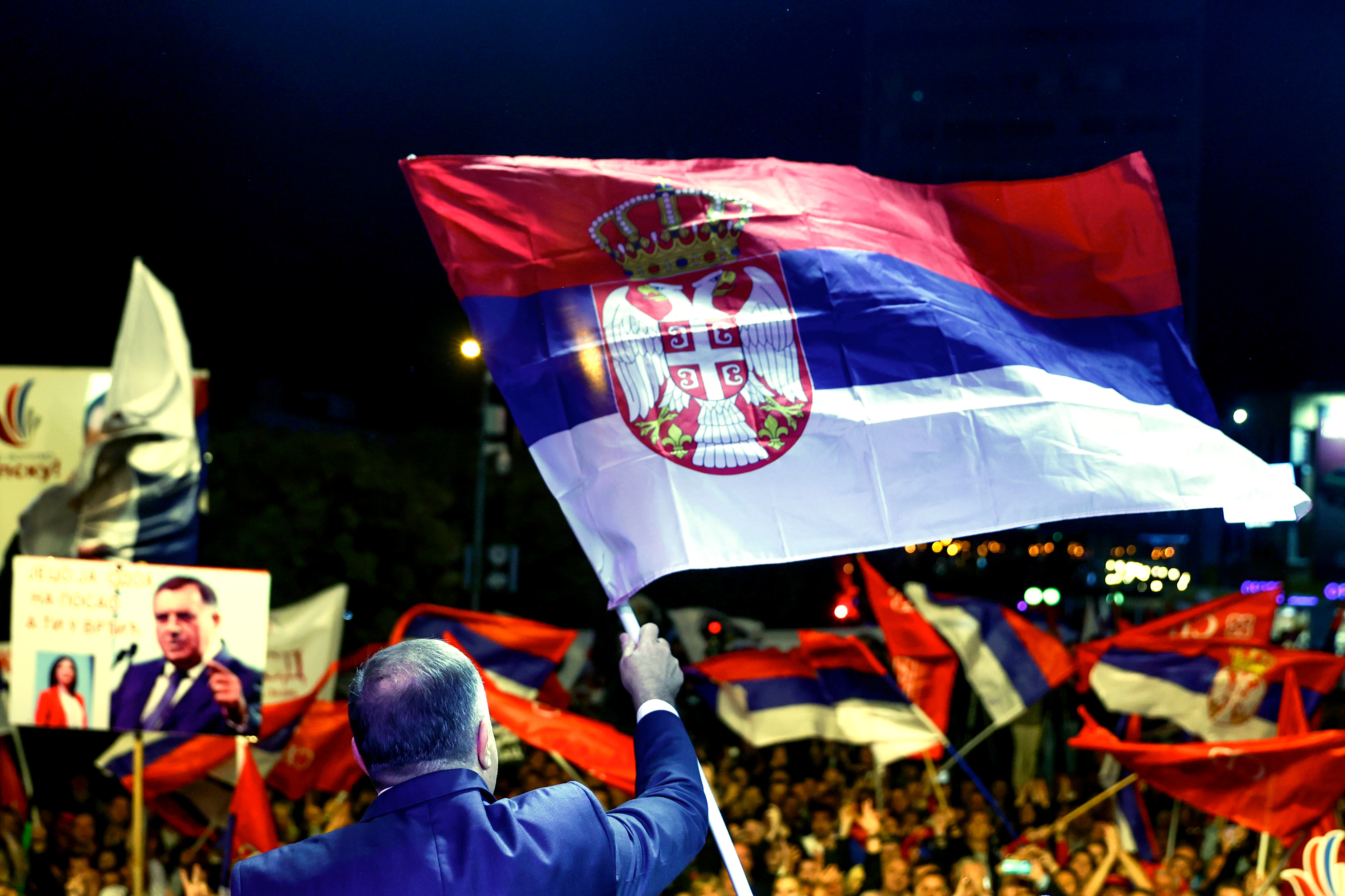 Bosnian Serb leader and member of the Bosnian Presidency Milorad Dodik waves with the Serbian flag to the thousands who gathered to support the &quot;people&#039;s rally for the defense of Republika Srpska&quot; protest in Banja Luka, Bosnia, Tuesday, Oct. 25, 2022.Tens of thousands of people rallied in Bosnia Tuesday to demand from electoral authorities to end a recount of ballots cast in one of the races in the country&rsquo;s Oct. 2 general election and confirm a staunchly pro-Russian politician as the president of its Serb-run part. [Armin Durgut/AP Photo] (AP Photo)
