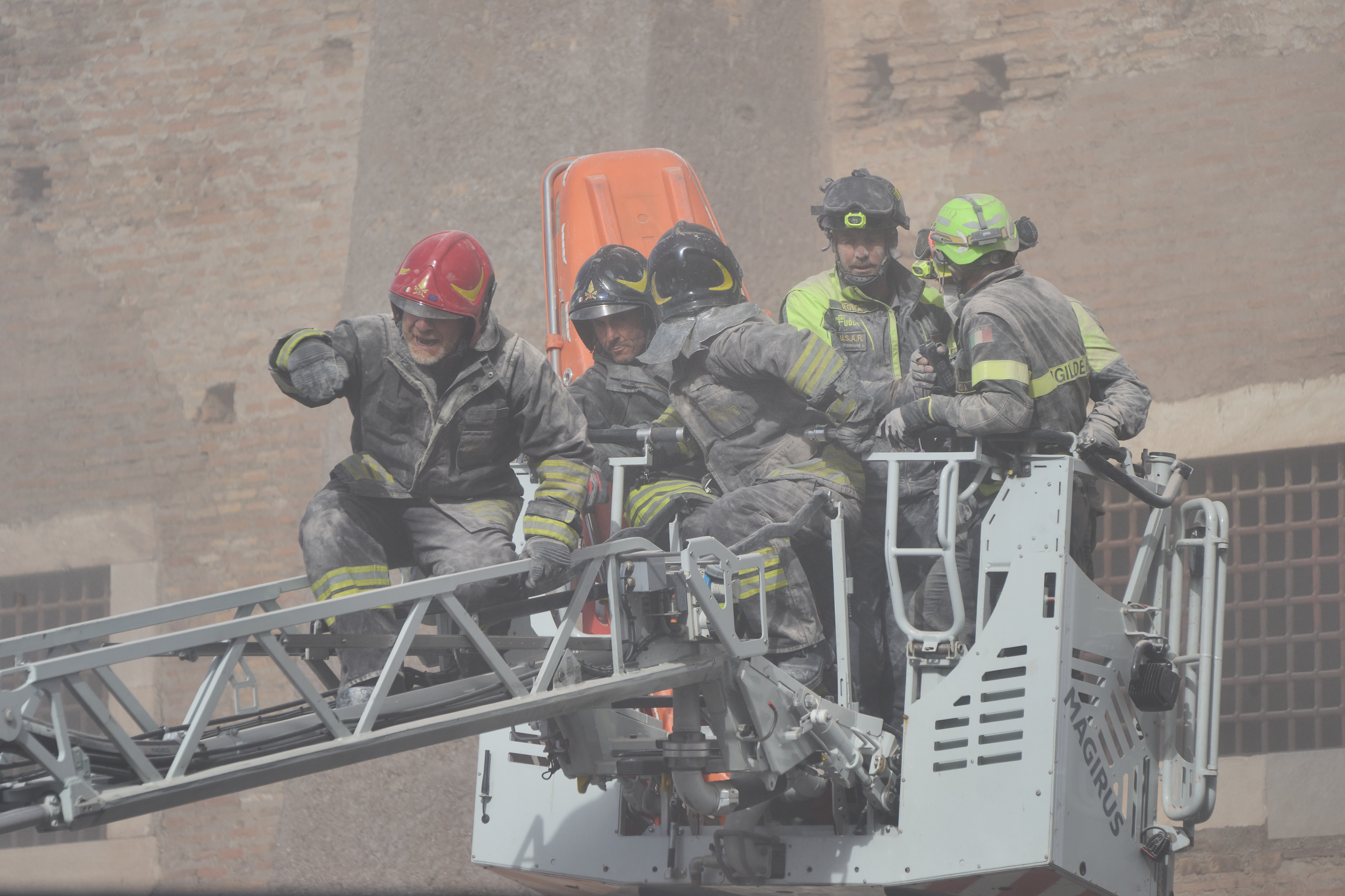 Firefighters work to rescue a construction worker from under the debris of the partially collapsed medieval Torre de Conti, meters away from the Colosseum in Rome, Monday, Nov. 3, 2025.