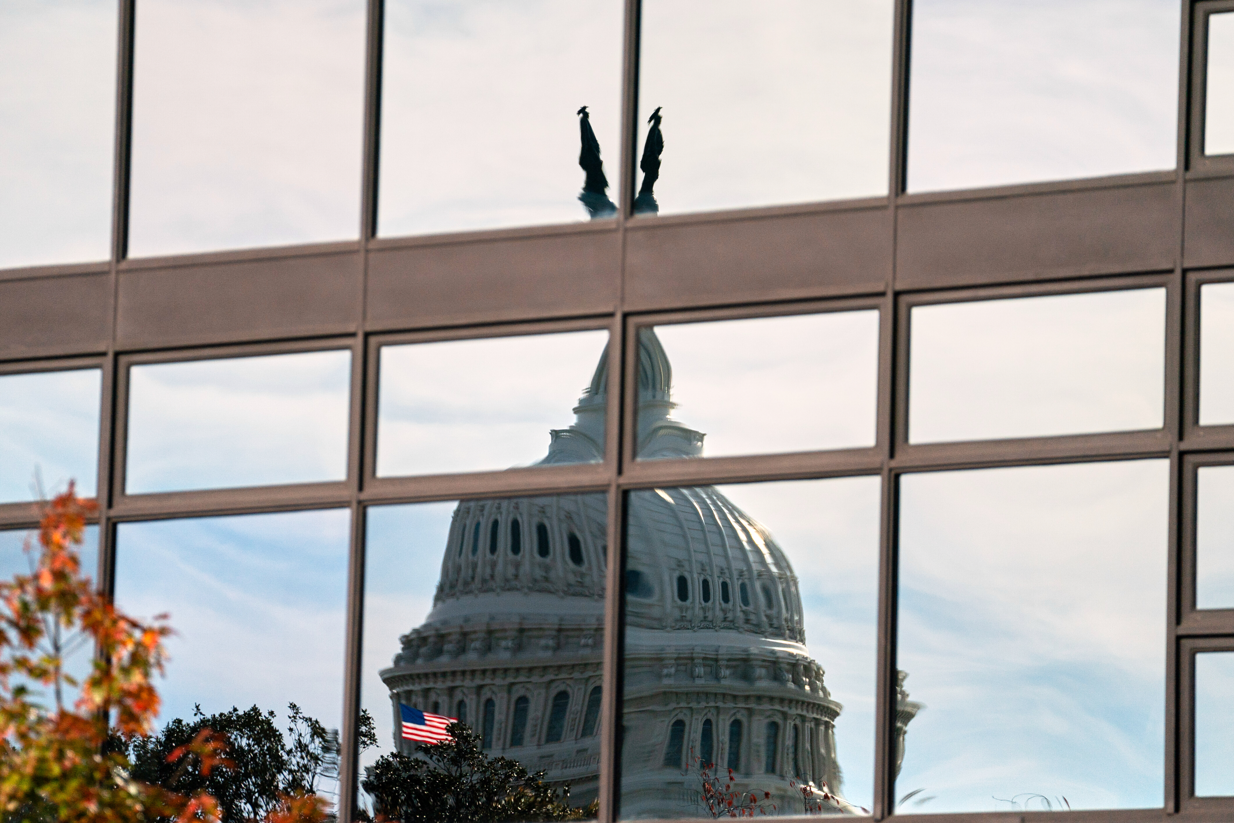 The Capitol dome is distorted by windows on the Teamsters' building, Tuesday, Nov. 4, 2025, in Washington.