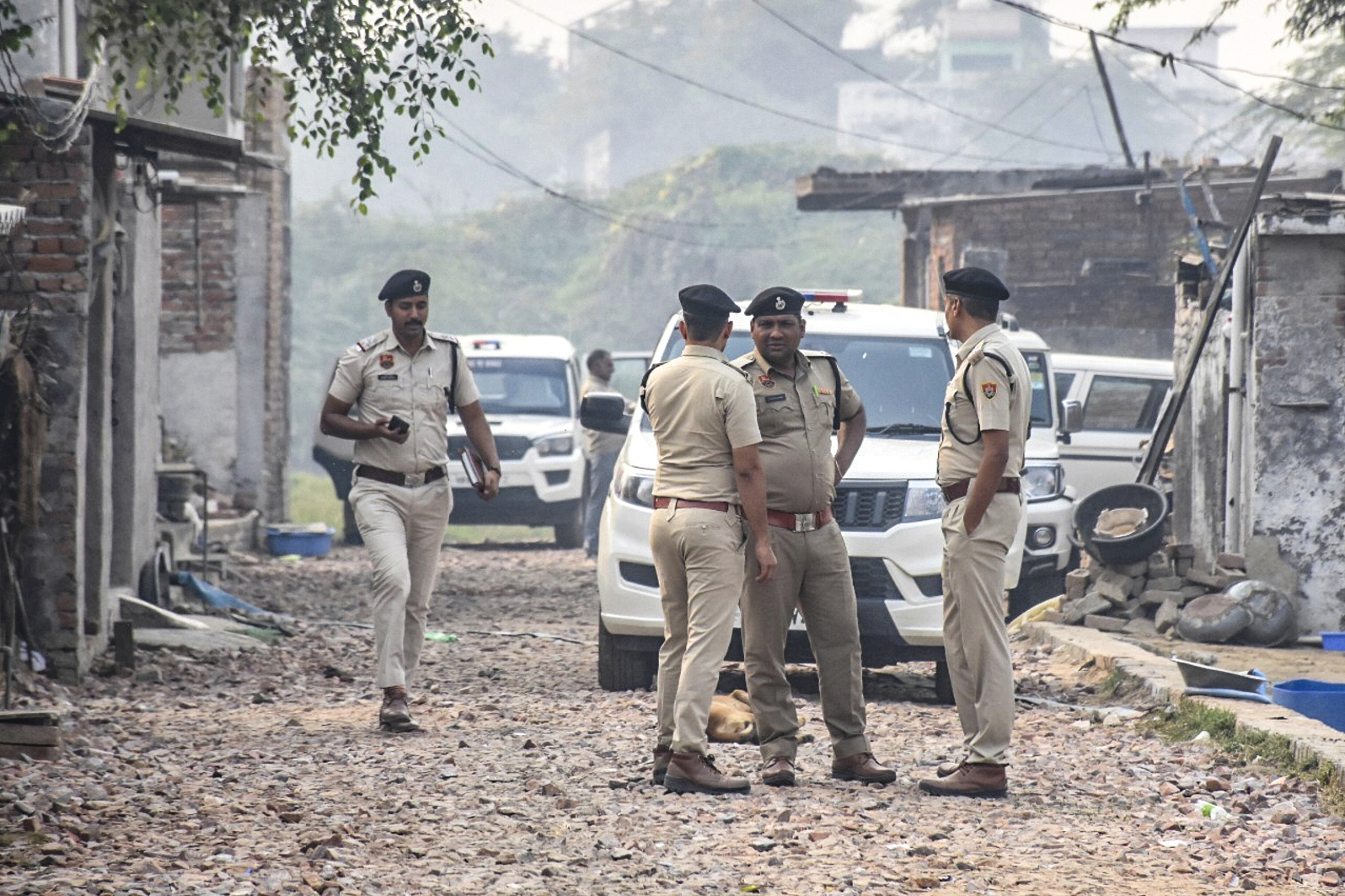 Security officials stand outside a house at Fatehpur Tagga, in Faridabad on the outskirts of New Delhi, India, Monday, Nov. 10, 2025. (AP Photo)