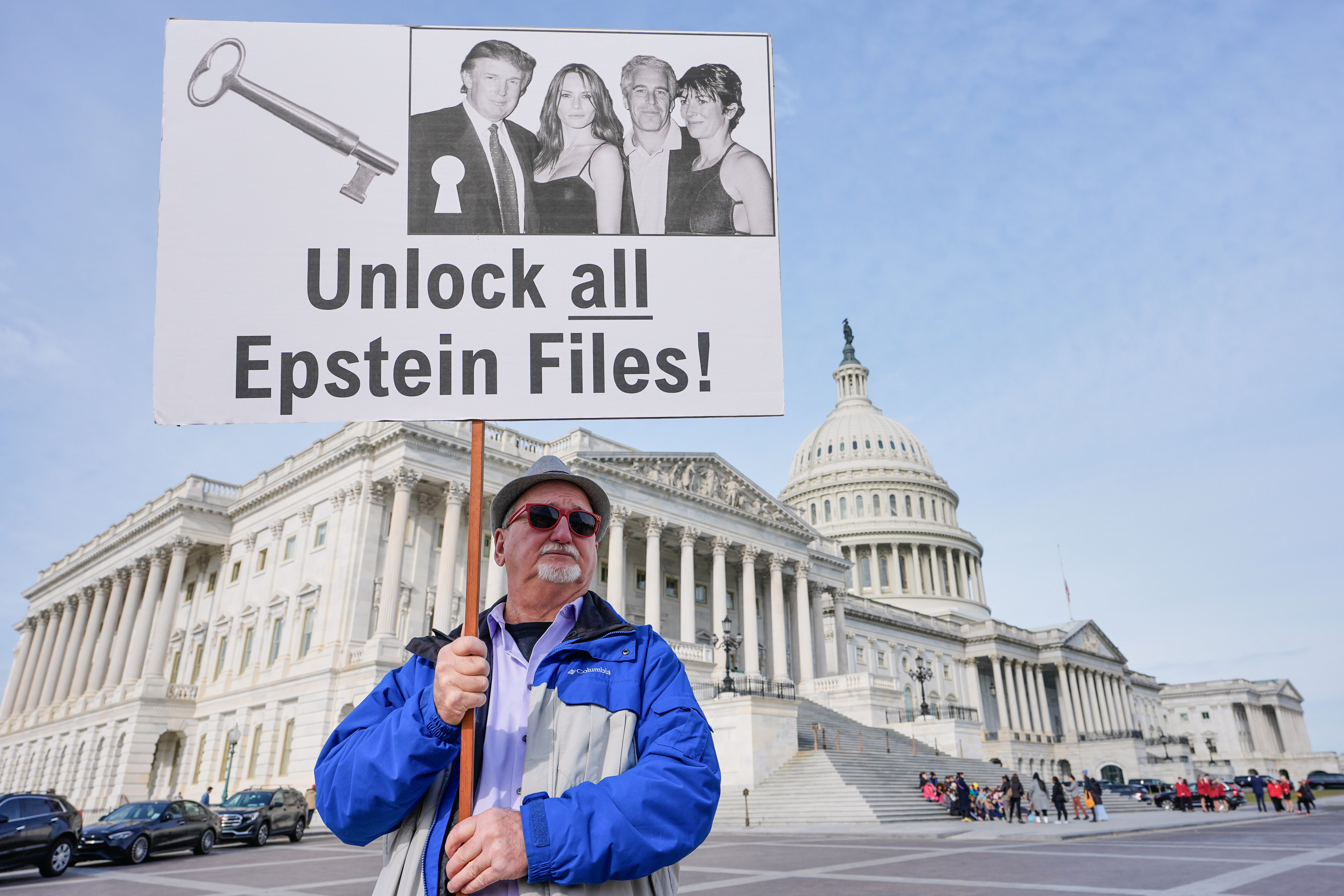 Gary Rush holds a sign before a news conference on the Epstein files in front of the US Capitol, on November 18 [Mariam Zuhaib/AP]