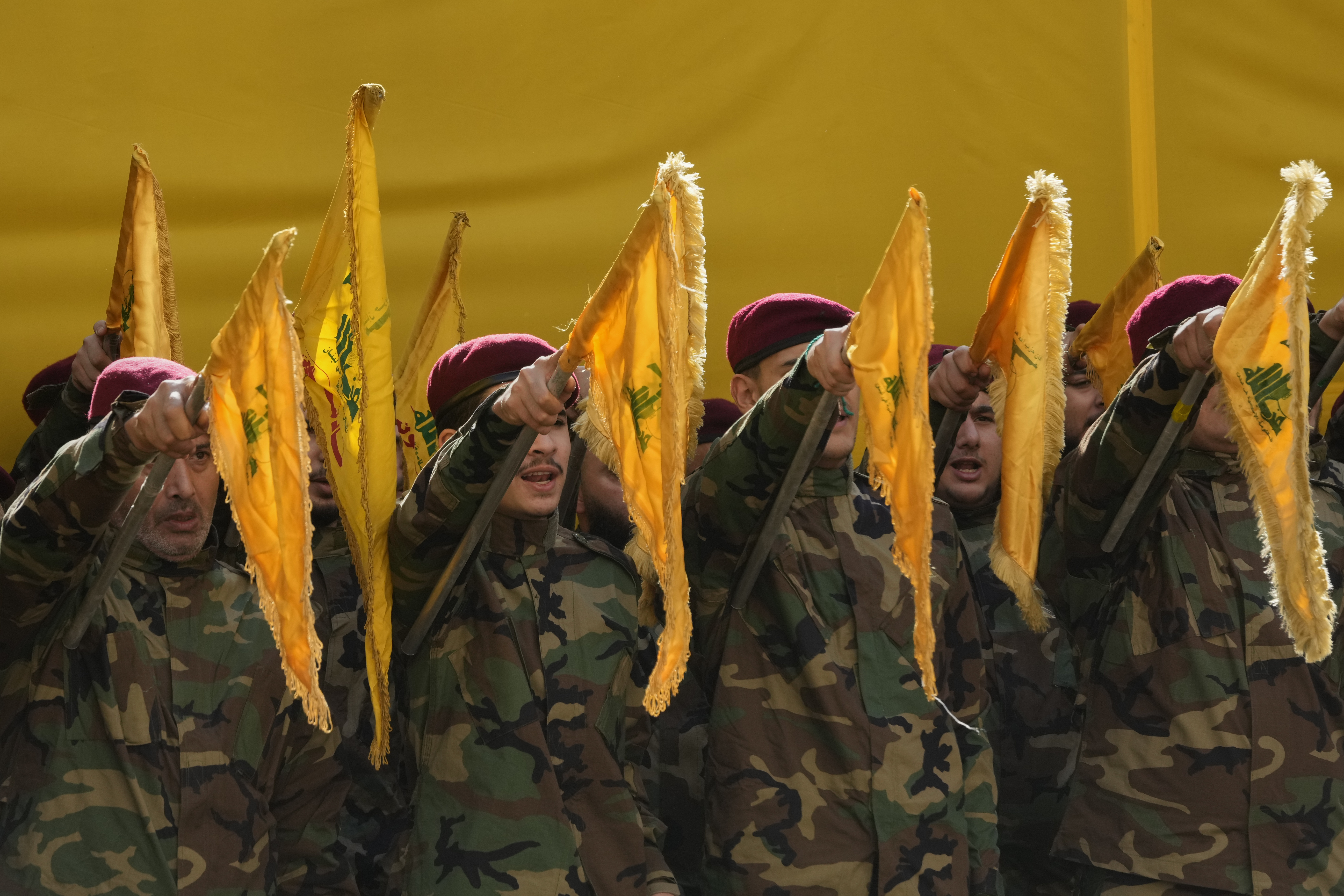 Hezbollah fighters raise their group's flags and chant slogans as they attend the funeral procession of Hezbollah's chief of staff, Haytham Tabtabai, and two other Hezbollah members who were killed in Sunday's Israeli airstrike, in a southern suburb of Beirut, Lebanon, Monday, November 24, 2025. [Hussein Malla/AP]