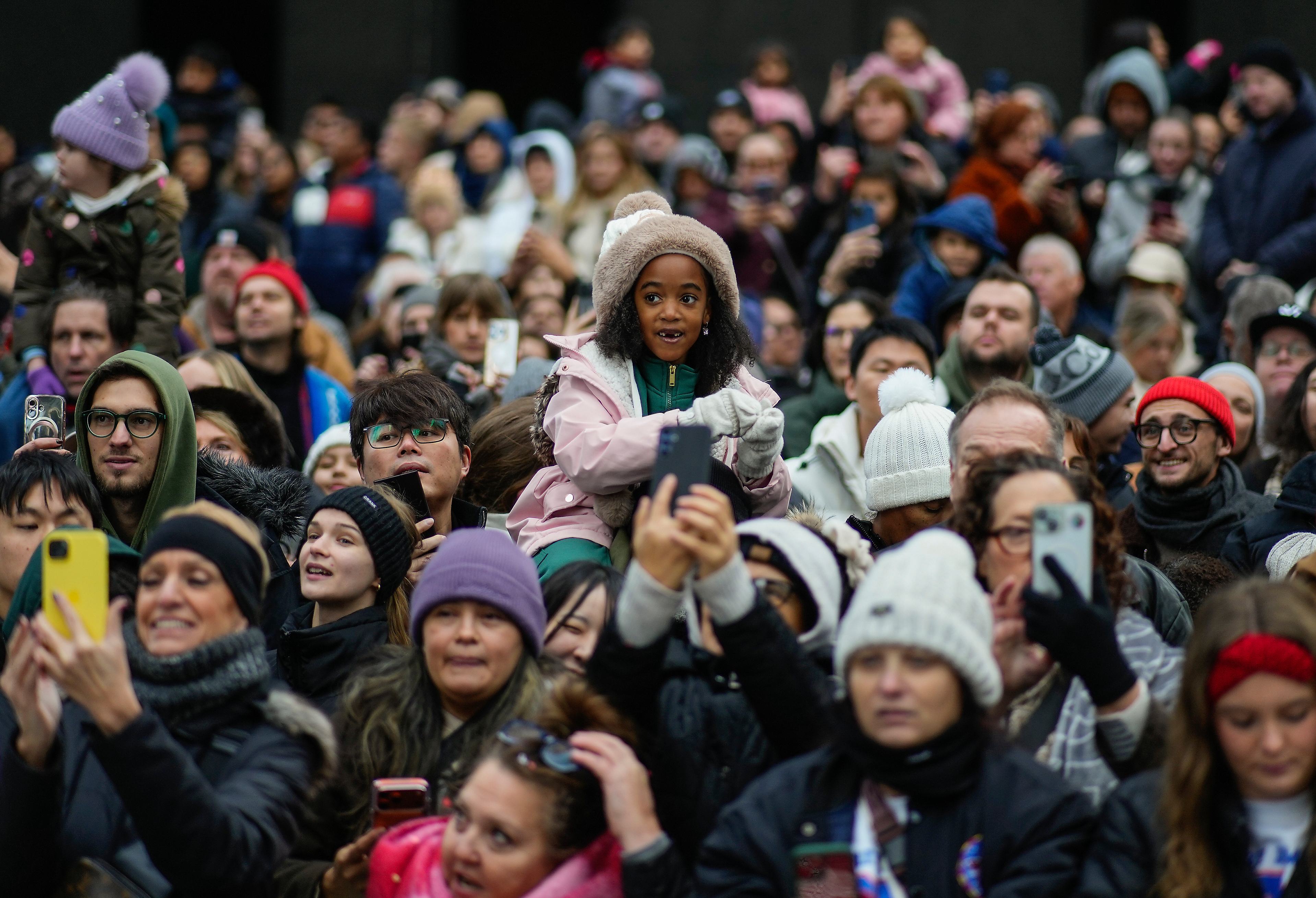 Crowds gather on Sixth Avenue to watch the Macy's Thanksgiving Day parade