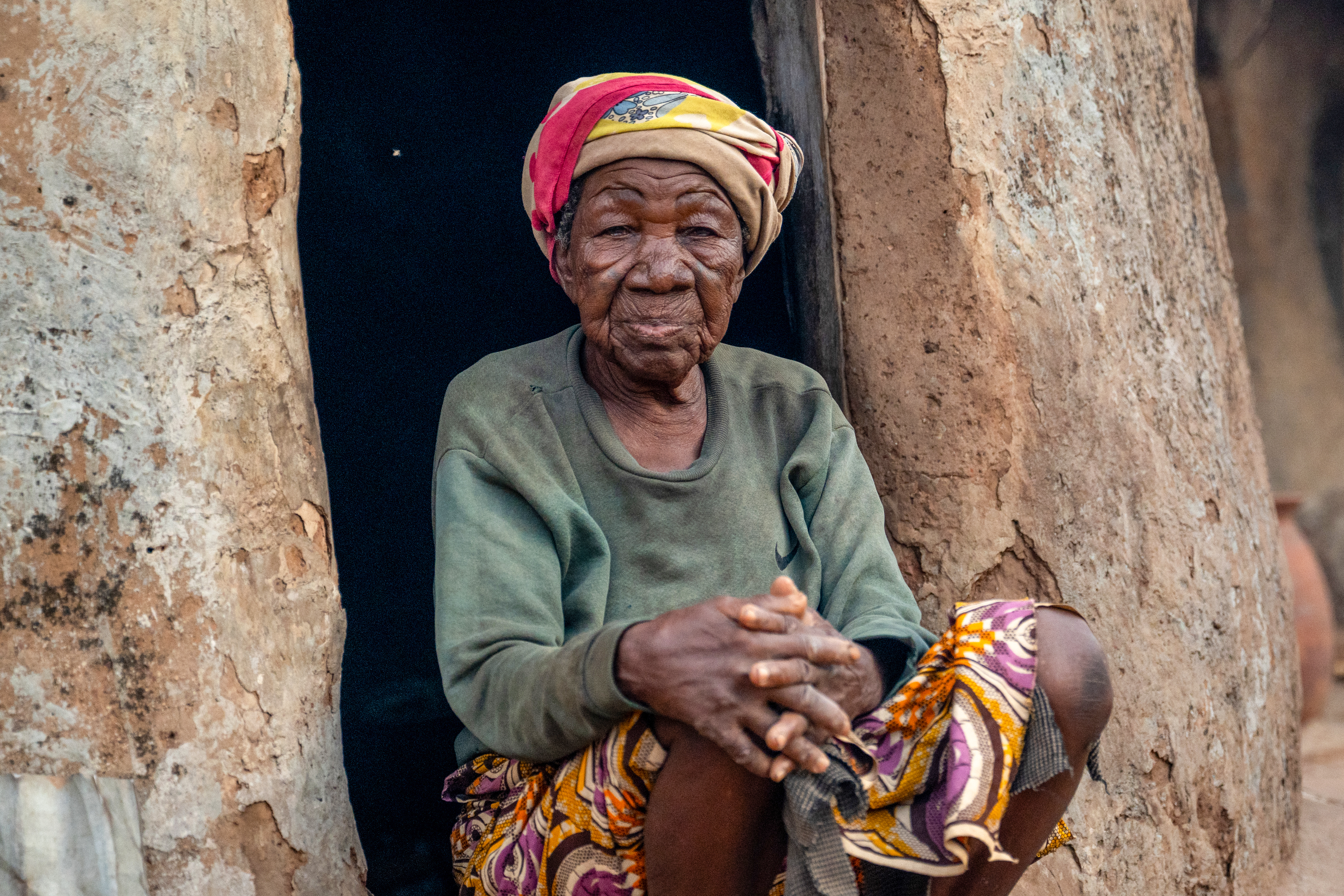 “I’ve lived in this camp for 45 years,” says Bachalibanoya. After her husband’s death, the children of his other wife accused her of witchcraft—an allegation that would alter the course of her life. Now the oldest resident of the Gambaga camp, she has lived in exile for more than four decades. [Claire Thomas/Al Jazeera]