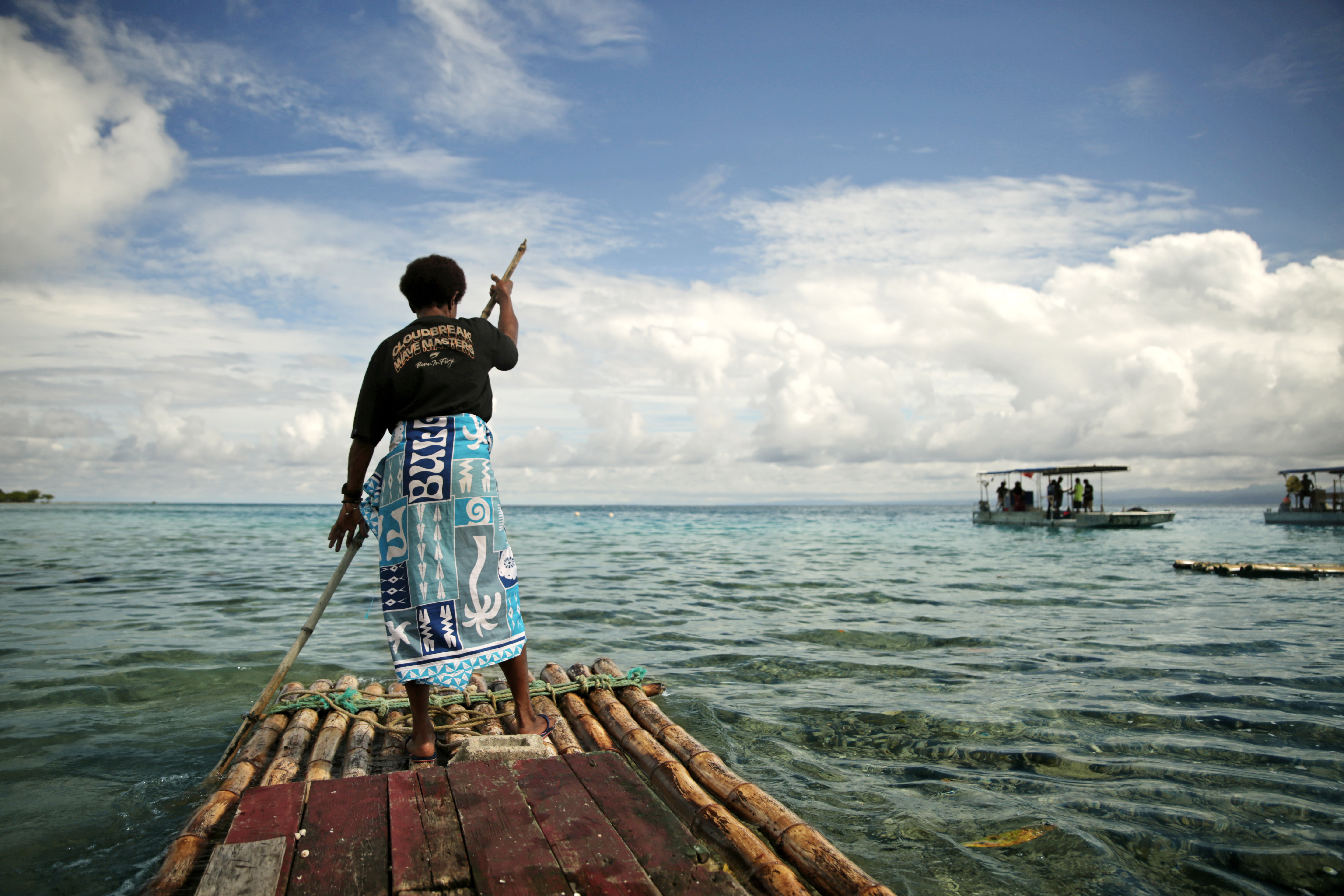 Jelly Ravea glides toward an oyster farm on a bilibili, a traditional Fijian raft made of bamboo.