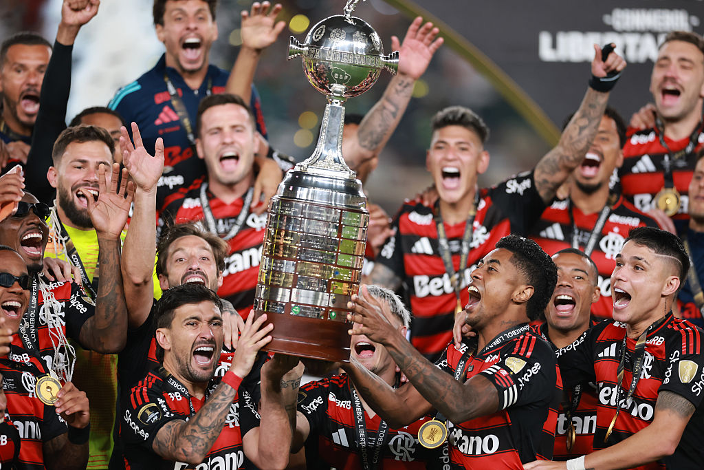 Giorgian de Arrascaeta and Bruno Henrique of Flamengo lift the Champion's trophy after winning the the 2025 Copa CONMEBOL Libertadores Final