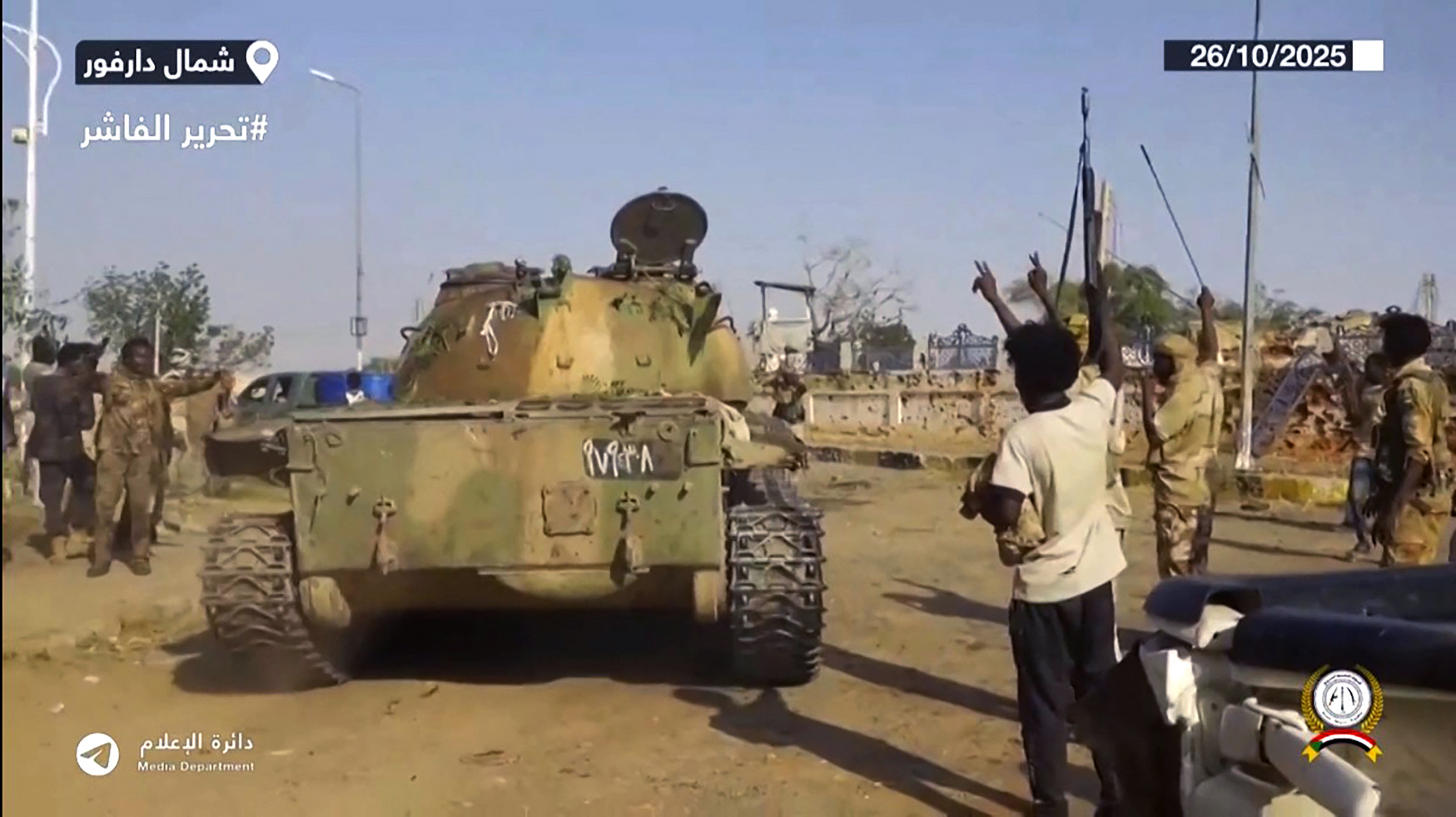 TOPSHOT - This image grab taken from handout video footage released on Sudan's paramilitary Rapid Support Forces (RSF) Telegram account on October 26, 2025, shows RSF fighters celebrating in the streets of El-Fasher in Sudan's Darfur.