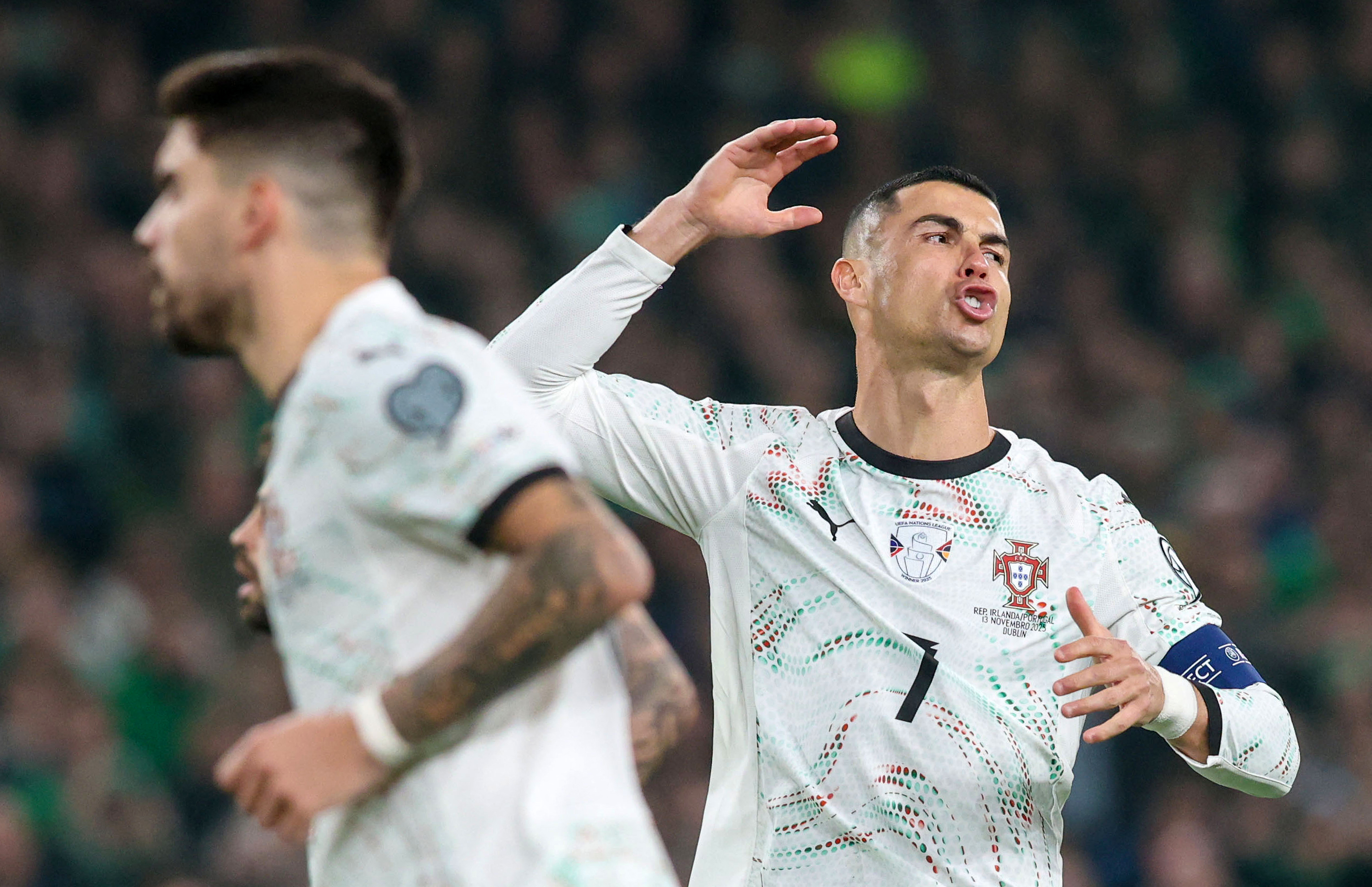 Portugal's forward Cristiano Ronaldo (R) reacts after missing a free kick during the men's football 2026 World Cup Group F qualifier between Ireland and Portugal at Aviva Stadium in Dublin on November 13, 2025. (Photo by Paul Faith / AFP)