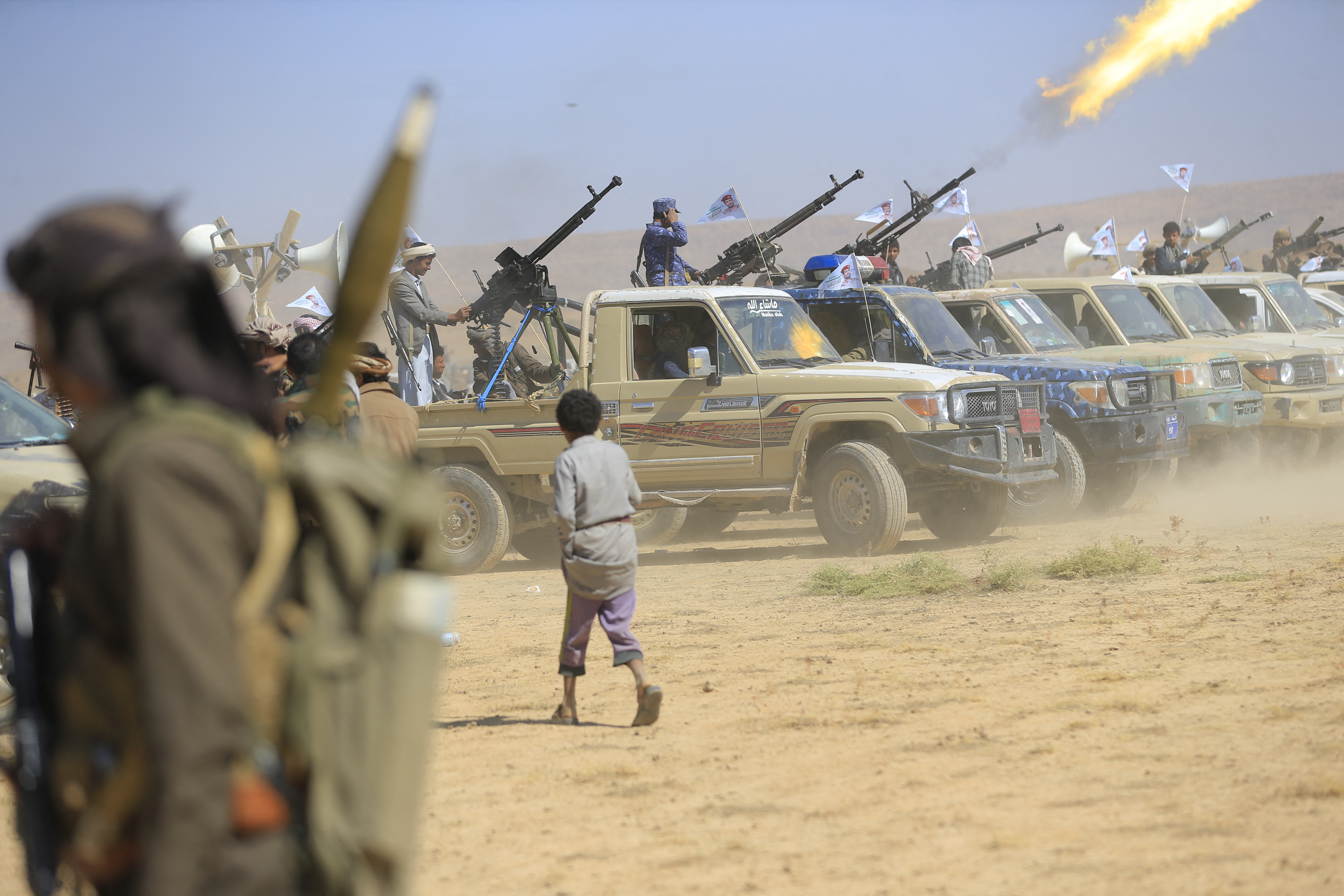 Yemeni fighters gather to mobilise, with rocket launchers atop military vehicles.