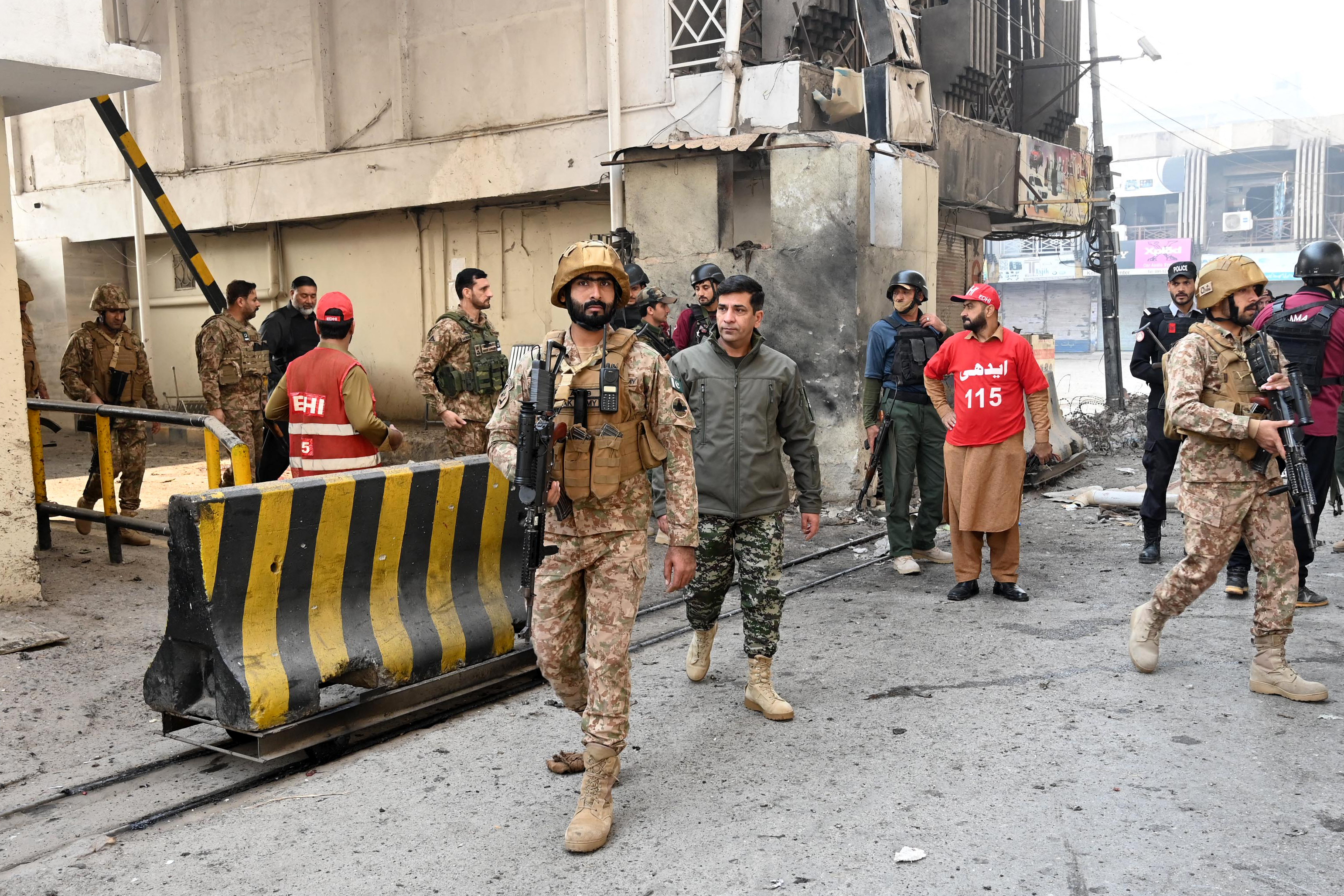Army personnel inspect the suicide attack site.