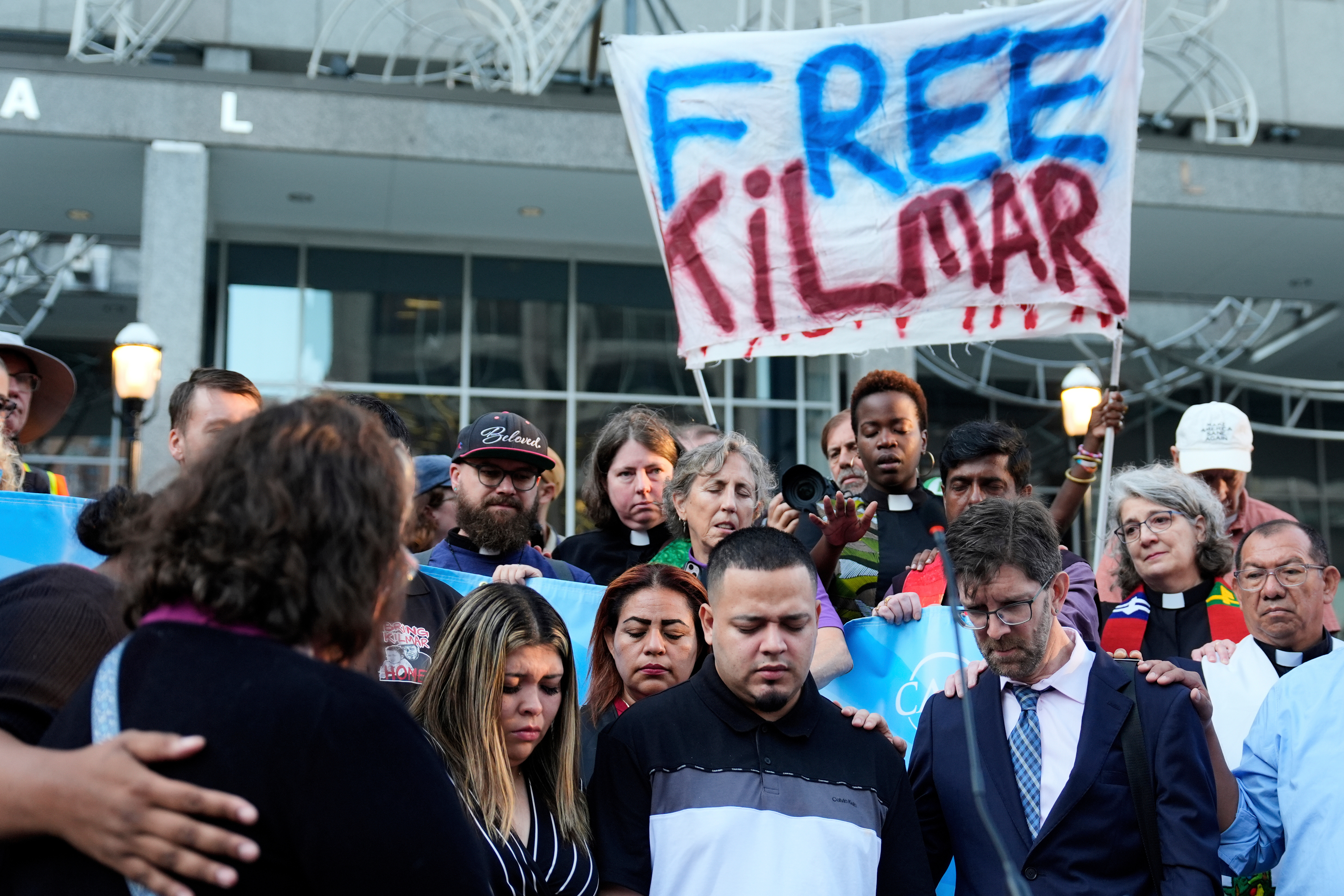 FILE - Foreground from right, Attorney Simon Sandoval-Moshenberg, Kilmar Abrego Garcia and Garcia's wife Jennifer Vasquez Sura attends a protest rally at the Immigration and Customs Enforcement field office in Baltimore, Monday, Aug. 25, 2025. (AP Photo/Stephanie Scarbrough, File)