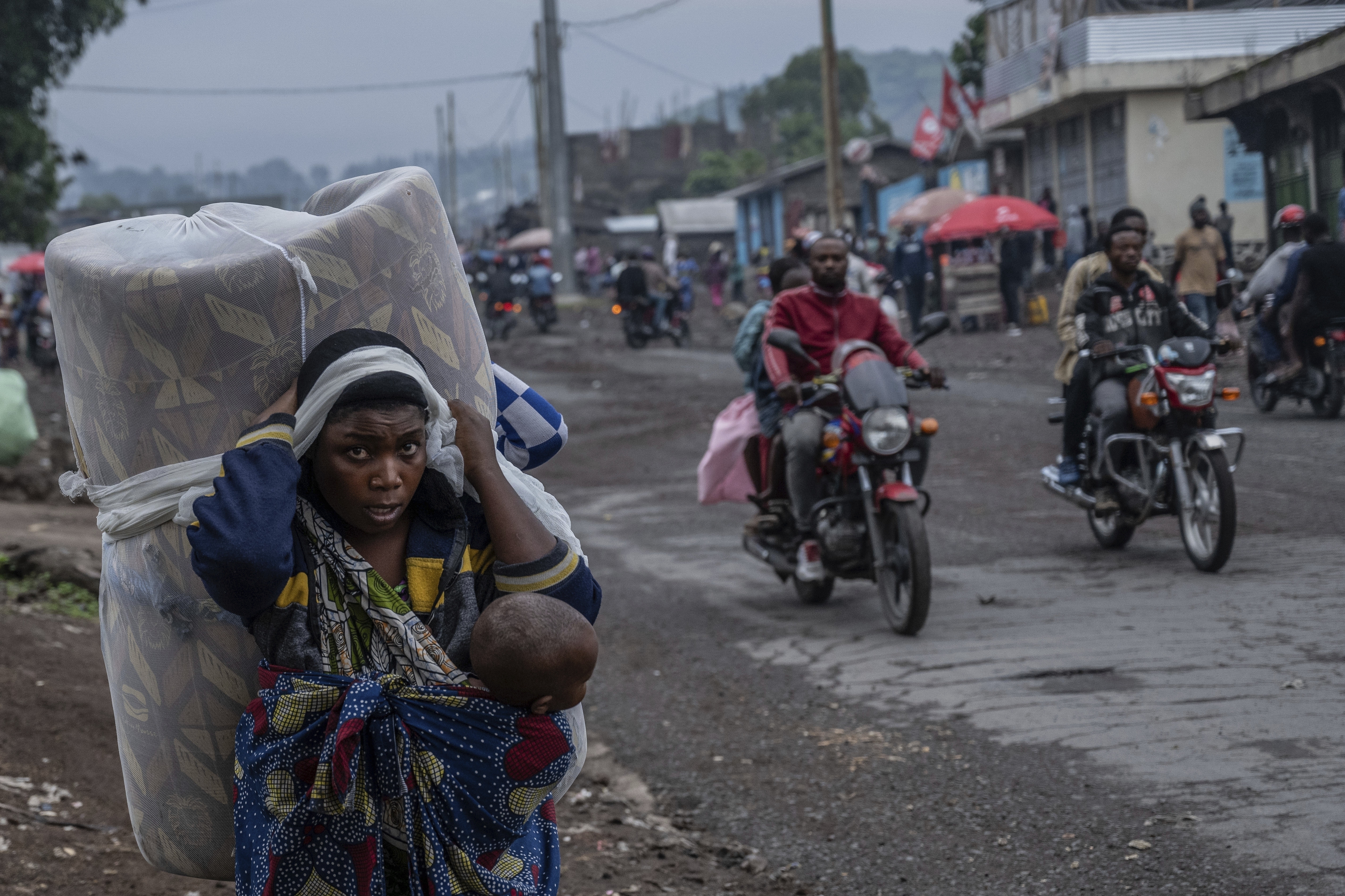 FILE - People displaced by the fighting with M23 rebels make their way to the center of Goma, Democratic Republic of the Congo, Sunday, Jan. 26, 2025. (AP Photo/Moses Sawasawa, File)