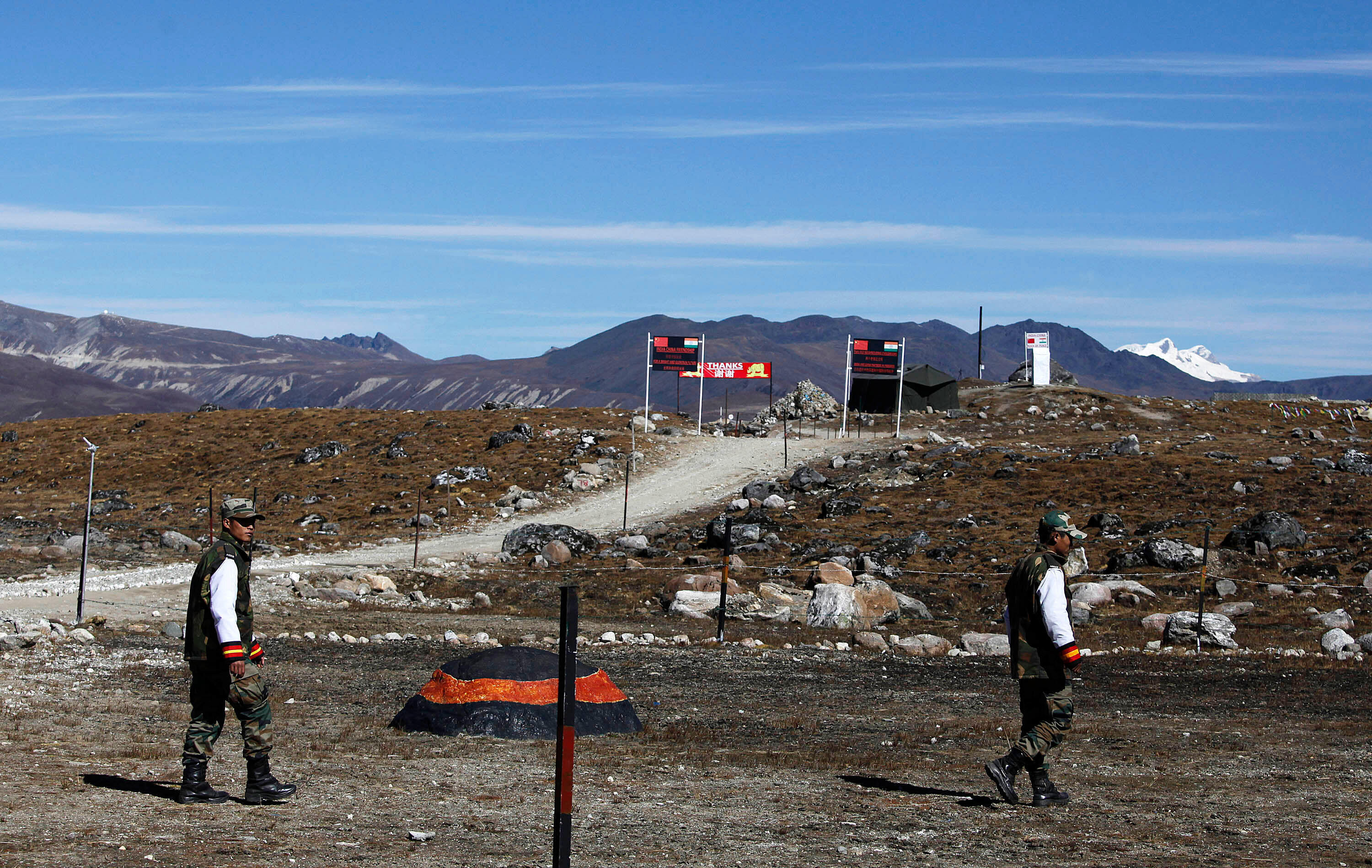 Indian army soldiers walk along the line of control at the Indo-China border.