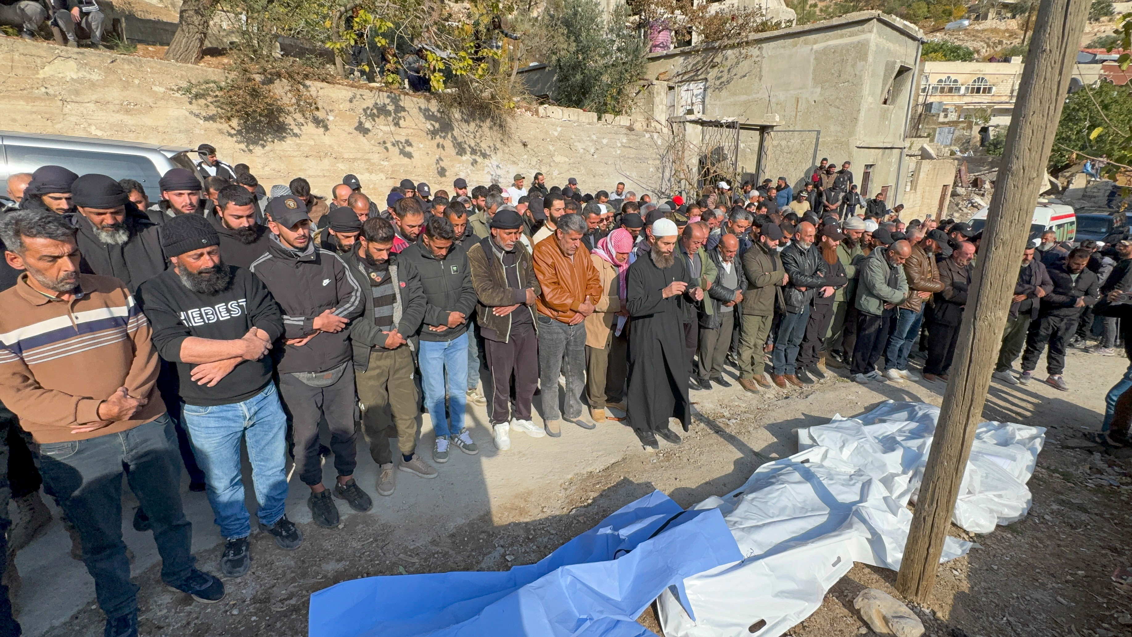 epa12554806 Syrians perform funeral prayers for several victims killed in the Israeli strike on the town of Beit Jinn in rural Damascus near Mount Hermon, Syria, 28 November 2025. The Damascus Countryside Health Directorate reported that 13 people were killed in the attack, while the Israeli army said it carried out a military operation in the town, resulting in the injury of six soldiers. These developments come amid escalating tensions near the Syrian Golan. EPA/MOHAMMED AL RIFAI