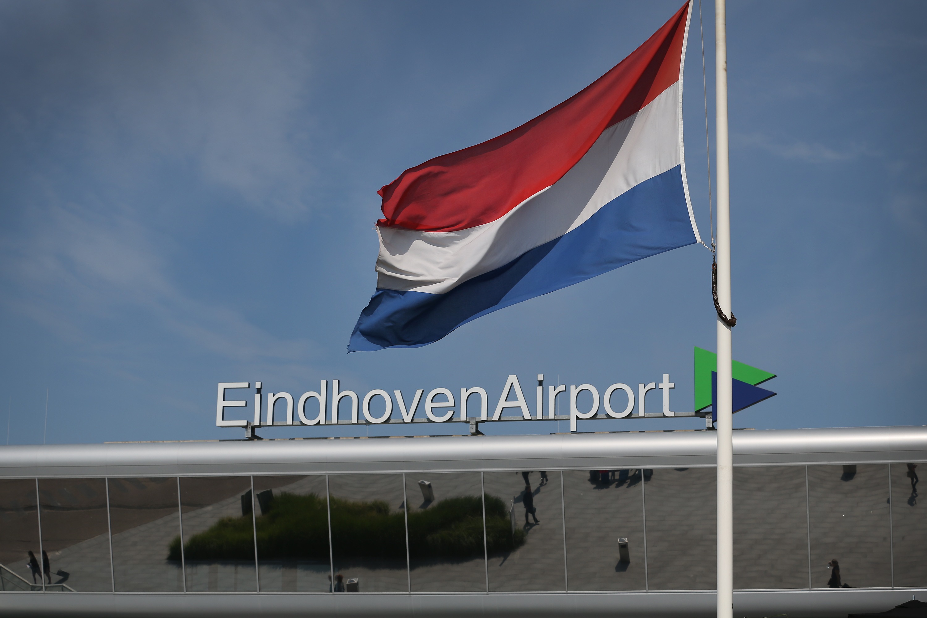 EINDHOVEN, NETHERLANDS - JULY 23: A Dutch flag flies at half mast on July 23, 2014 at Eindhoven Airport, Netherlands. Later the first 50 bodies will be repatriated to Eindhoven military airbase. Today the people of the Netherlands are holding a national day of mourning. Malaysian Airlines flight MH17 was travelling from Amsterdam to Kuala Lumpur when it crashed in eastern Ukraine killing all 298 passengers. The aircraft was allegedly shot down by a missile and investigations continue to find the perpetrators of the attack. (Photo by Peter Macdiarmid/Getty Images)