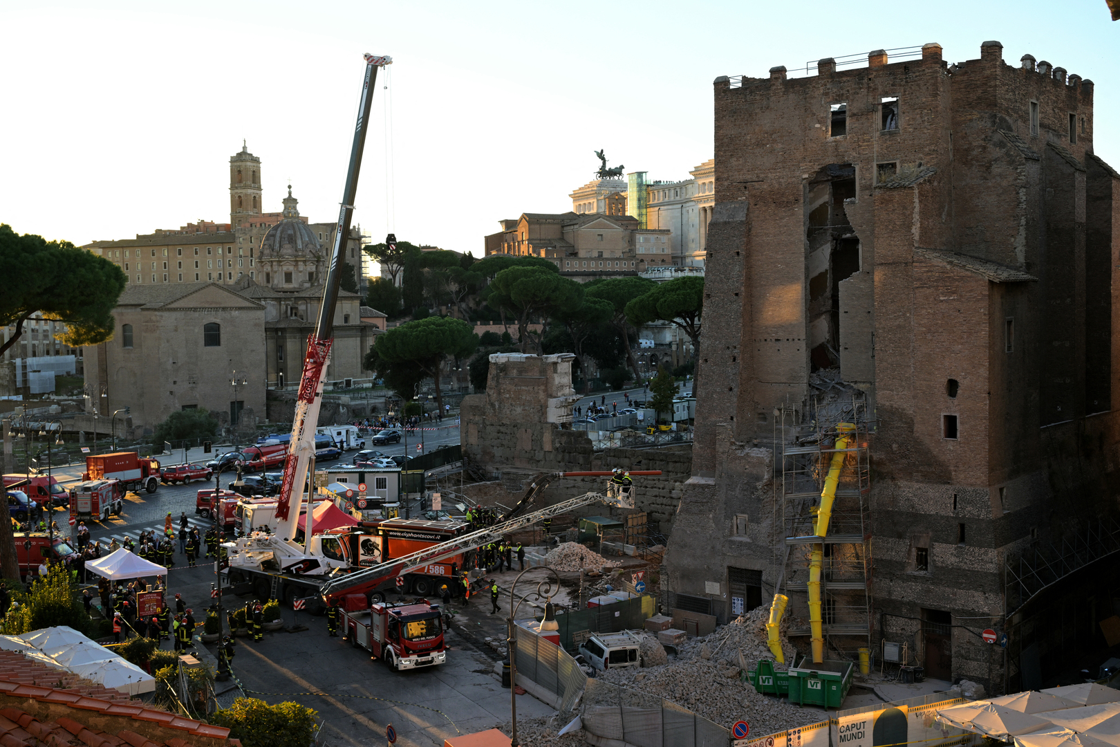 Firefighters work on the site after a part of medieval tower &quot;Torre dei Conti&quot; collapses near the Roman Forum in the historic center of Rome on November 3, 2025. Three workers inside were evacuated, with one taken to hospital in critical condition, a spokesman for firefighters told AFP. But one worker remained inside, according to an official from the mayor&#039;s office. [Tiziana Fabi/AFP]