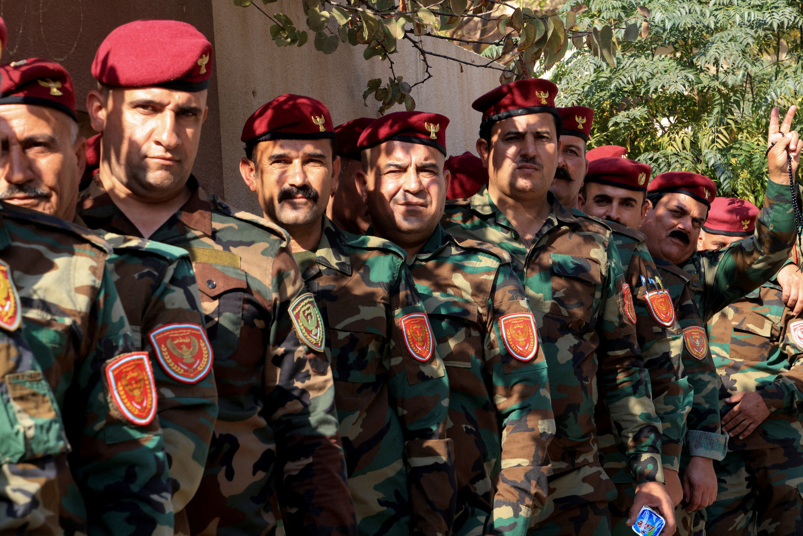Kurdish security forces wait outside a polling station to vote during a special voting, two days before polls open to the public in a parliamentary election in Duhok, Iraq on Nov. 9, 2025. [Ari Jalal/Reuters]