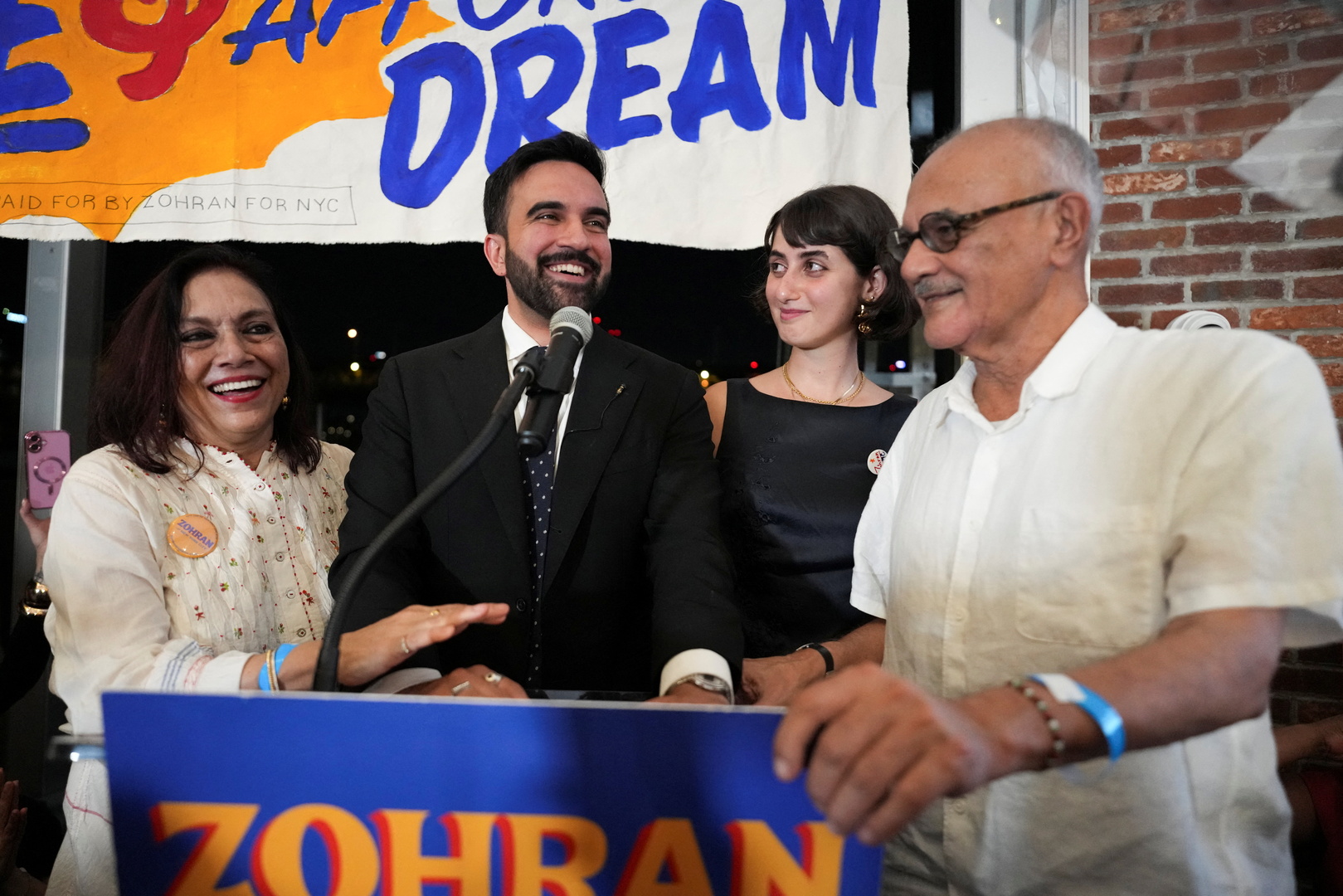 Zohran Mamdani reacts next to his parents Mahmood Mamdani and Mira Nair and wife Rama Duwaji during a watch party for his primary election in New York City, US on June 25, 2025. [David Delgado/Reuters]
