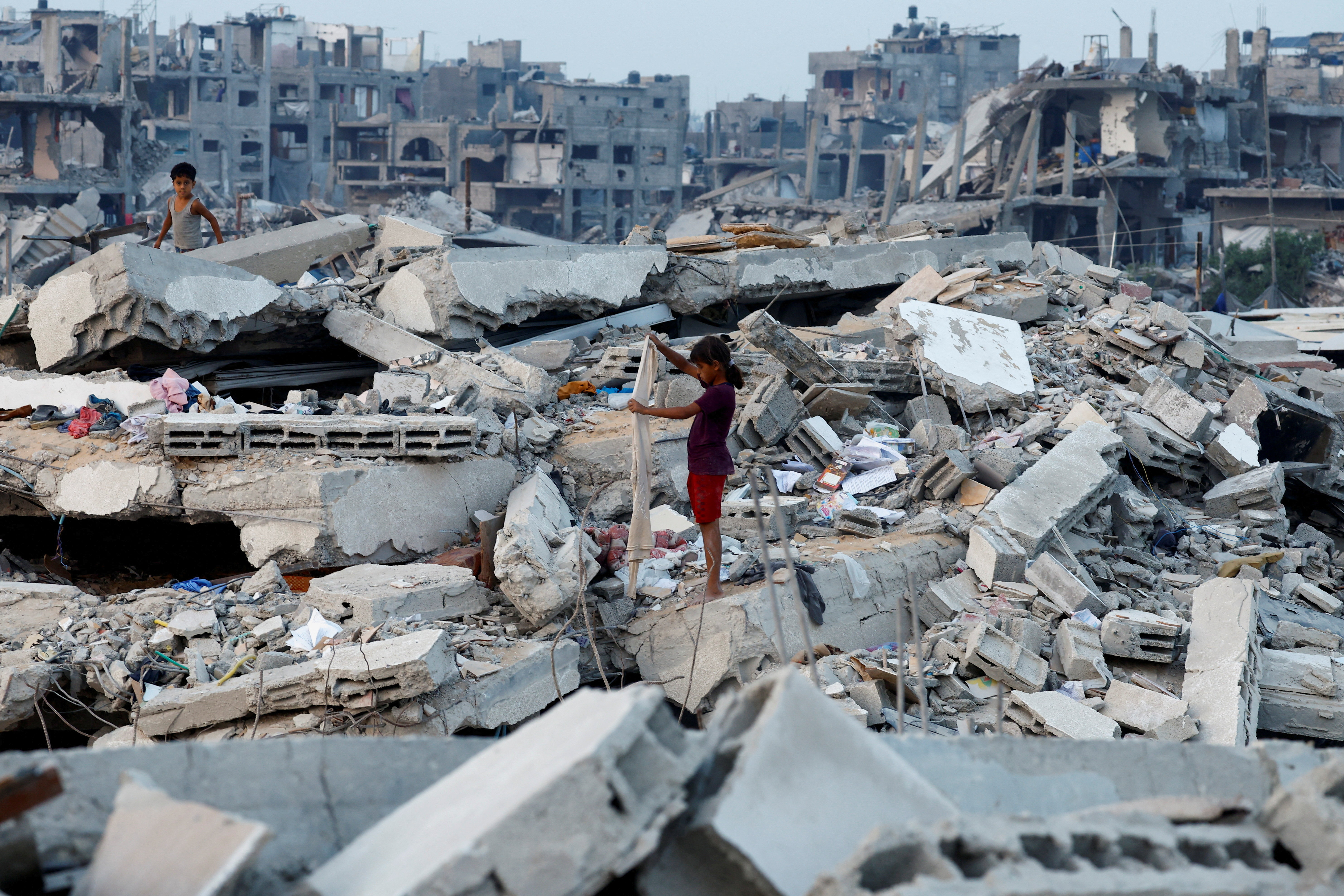 Palestinian children stand on the rubble of destroyed buildings, amid a ceasefire between Israel and Hamas, in Jabalia, northern Gaza Strip, November 6, 2025. REUTERS/Mahmoud Issa