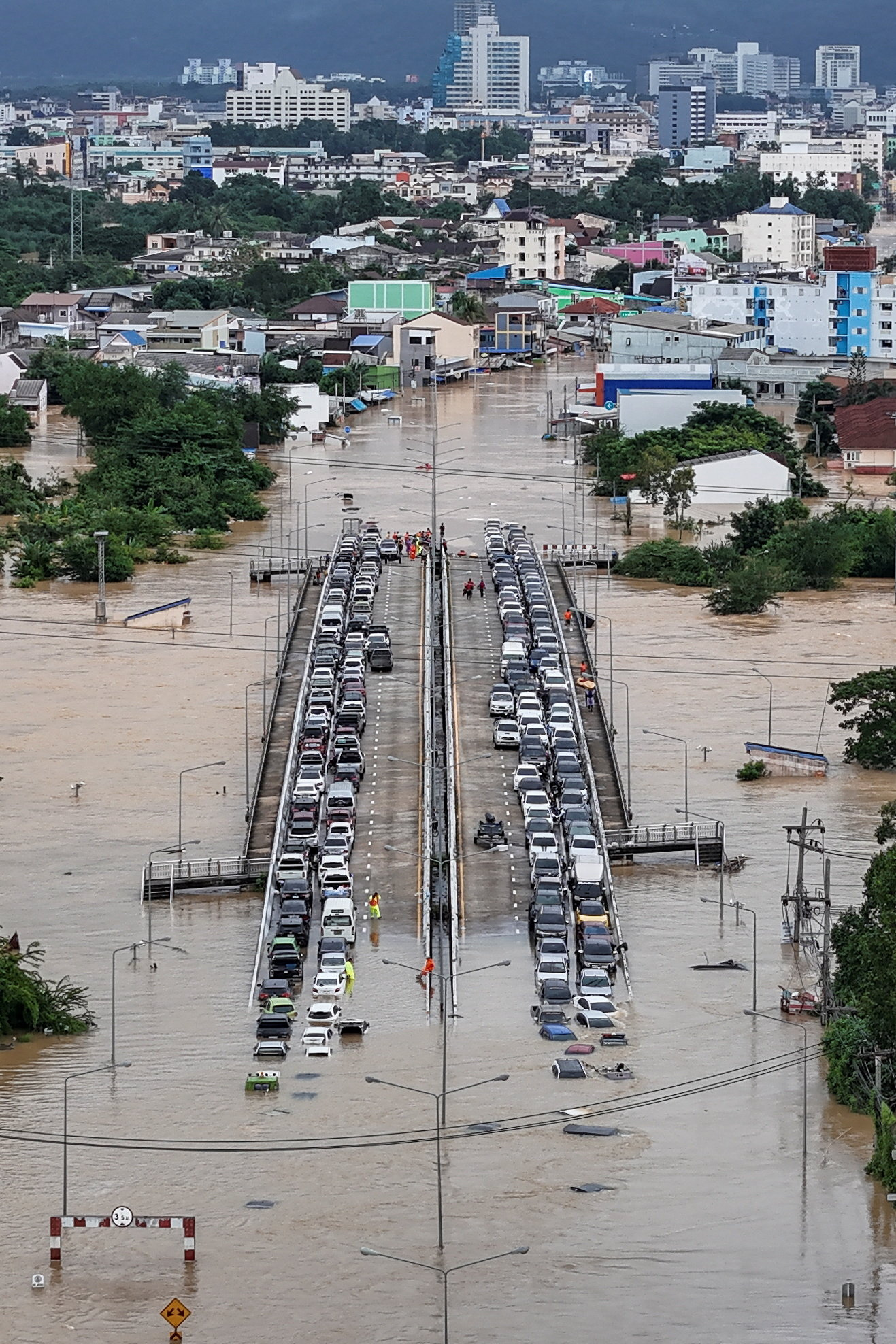 A drone view shows cars parked on a bridge to escape floodwaters in Hat Yai