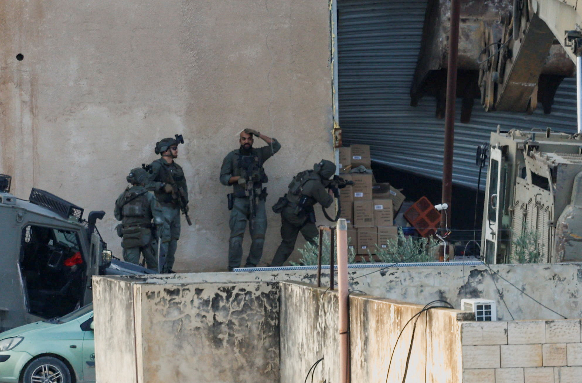 Israeli soldiers take position during a deadly raid in Jenin in the occupied West Bank